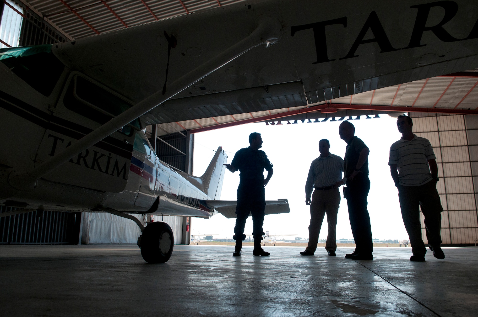Members of the 39th Air Base Wing talk with a Turkish air force officer at a flight school Sept. 10, 2012, in Adana, Turkey. Airmen of the 39th ABW visited the Adana airport and a flight school as part of an annual mid-air collision avoidance conference and to maintain their relationship with Turkish air traffic controllers. (U.S. Air Force photo by Senior Airman Daniel Phelps/Released)