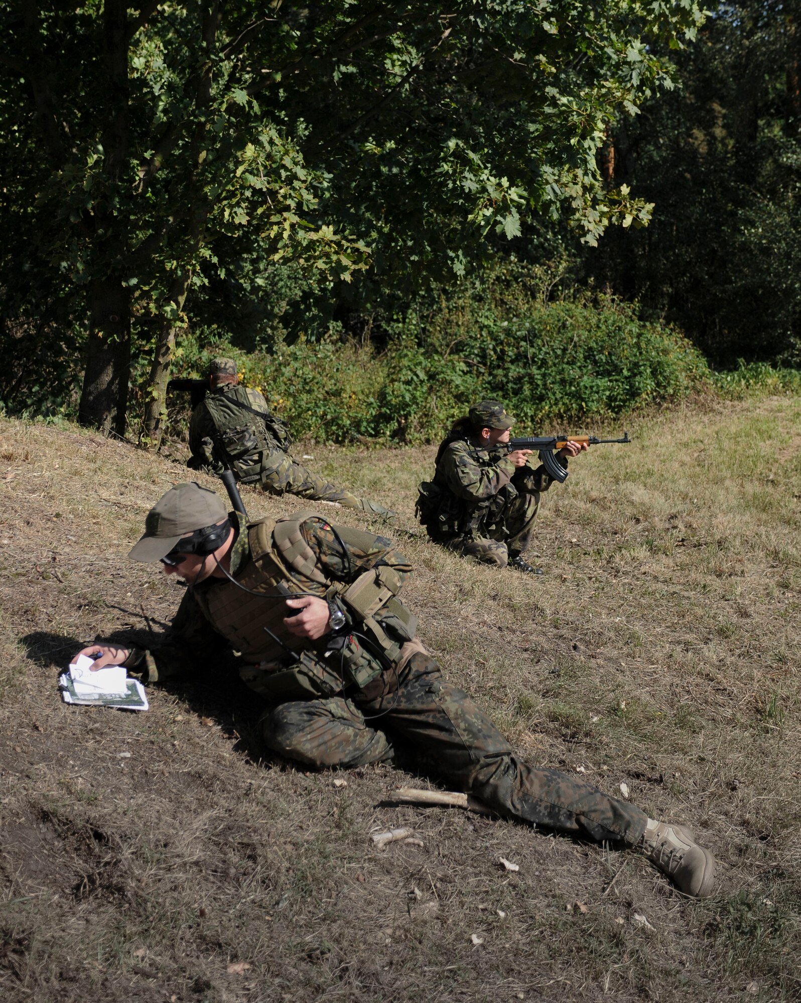 NAMEST AIR BASE, Czech Republic -- German air force 1st Lt. Peter Kuechler, forward air controller, communicates with Czech Republic helicopter pilots as Czech Republic air force ground forces provide cover from enemy threats during a forward air control training scenario a part of Ramstein Rover 2012 Sept. 11, here. During this scenario German forward air controllers, who are based out of Baumholder, Germany, communicated with Czech Republic helicopter pilots to establish targets for the ground commander while mitigating risks to civilians and civilian assets. Sixteen NATO member nations are participating in RARO 12 to include: The United States, United Kingdom, Czech Republic, Belgium, Estonia, France, Germany, Greece, Italy, Latvia, the Netherlands, Norway, Poland, Slovakia, Slovenia and Turkey. The 81st Fighter Squadron is participating in the exercise as the United States counterpart to provide close air support for forward air controllers. This squadron often conducts close air support and forward air control missions with the FACs from Baumholder. Each nation's participation in RARO 12 ensures effective employment of airpower in support of alliance or coalition forces while mitigating risks to civilians in contingency operations. (U.S. Air Force photo by Senior Airman Natasha Stannard/Released)




