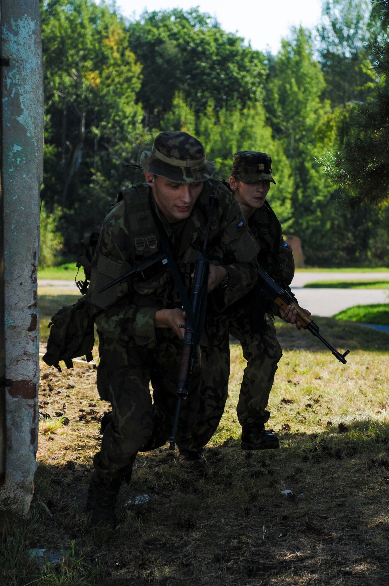 NAMEST AIR BASE, Czech Republic -- Czech Republic air force Lieutenant Jan Talacko, Exercise ground commander, and his troops run for cover as they pursue an enemy target during a forward air control training scenario a part of Ramstein Rover 2012 Sept. 11, here. During this scenario German forward air controllers, who are based out of Baumholder, Germany, communicated with Czech Republic helicopter pilots to establish targets for the ground commander while mitigating risks to civilians and civilian assets. Sixteen NATO member nations are participating in RARO 12 to include: The United States, United Kingdom, Czech Republic, Belgium, Estonia, France, Germany, Greece, Italy, Latvia, the Netherlands, Norway, Poland, Slovakia, Slovenia and Turkey. The 81st Fighter Squadron is participating in the exercise as the United States counterpart to provide close air support for forward air controllers. This squadron often conducts close air support and forward air control missions with the FACs from Baumholder. Each nation's participation in RARO 12 ensures effective employment of airpower in support of alliance or coalition forces while mitigating risks to civilians in contingency operations. (U.S. Air Force photo by Senior Airman Natasha Stannard/Released)