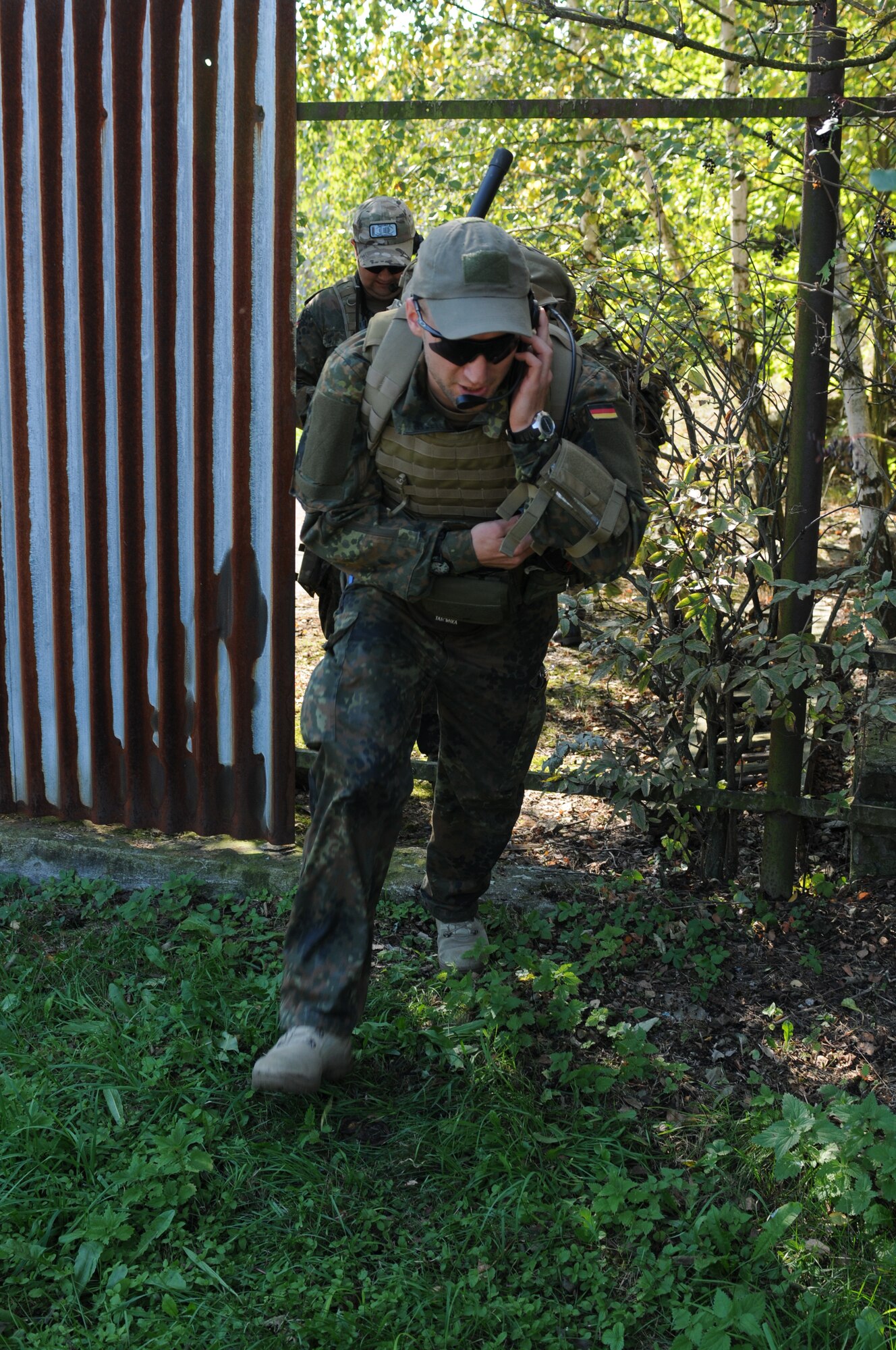 NAMEST AIR BASE, Czech Republic -- German air force 1st Lt. Peter Kuechler, forward air controller, communicates with Czech Republic helicopter pilots while running to covered area as he pursues enemy targets during a forward air control training scenario a part of Ramstein Rover 2012 Sept. 11, here. During this scenario German forward air controllers, who are based out of Baumholder, Germany, communicated with Czech Republic helicopter pilots to establish targets for the ground commander while mitigating risks to civilians and civilian assets. Sixteen NATO member nations are participating in RARO 12 to include: The United States, United Kingdom, Czech Republic, Belgium, Estonia, France, Germany, Greece, Italy, Latvia, the Netherlands, Norway, Poland, Slovakia, Slovenia and Turkey. The 81st Fighter Squadron is participating in the exercise as the United States counterpart to provide close air support for forward air controllers. This squadron often conducts close air support and forward air control missions with the FACs from Baumholder. Each nation's participation in RARO 12 ensures effective employment of airpower in support of alliance or coalition forces while mitigating risks to civilians in contingency operations. (U.S. Air Force photo by Senior Airman Natasha Stannard/Released)