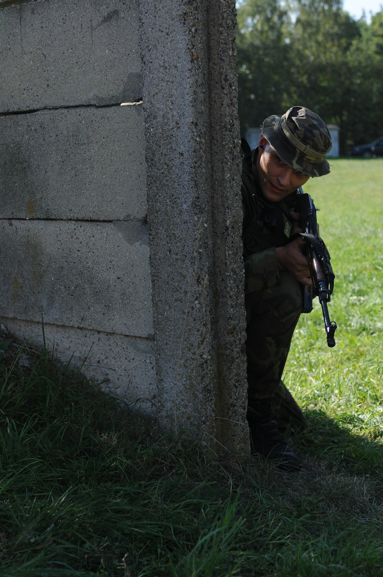 NAMEST AIR BASE, Czech Republic -- Czech Republic air force Lieutenant Jan Talacko, Exercise ground commander, checks the area for threats before moving on to a new location while in search of an enemy target during a forward air control training scenario a part of Ramstein Rover 2012 Sept. 11, here. During this scenario German forward air controllers, who are based out of Baumholder, Germany, communicated with Czech Republic helicopter pilots to establish targets for the ground commander while mitigating risks to civilians and civilian assets. Sixteen NATO member nations are participating in RARO 12 to include: The United States, United Kingdom, Czech Republic, Belgium, Estonia, France, Germany, Greece, Italy, Latvia, the Netherlands, Norway, Poland, Slovakia, Slovenia and Turkey. The 81st Fighter Squadron is participating in the exercise as the United States counterpart to provide close air support for forward air controllers. This squadron often conducts close air support and forward air control missions with the FACs from Baumholder. Each nation's participation in RARO 12 ensures effective employment of airpower in support of alliance or coalition forces while mitigating risks to civilians in contingency operations. (U.S. Air Force photo by Senior Airman Natasha Stannard/Released)