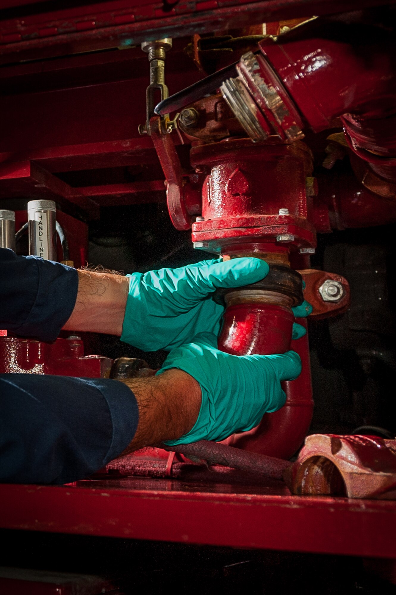 Ricardo Silva, 65th Logistics Readiness Squadron, fire truck maintenance specialist, replaces an old fill system with a new drain system on a 1986 P-19 fire truck, Sept. 10, 2012, Lajes Field.  The fire truck maintenance crew upgraded the 65th Civil Engineering Squadron’s crash response vehicles enabling the use of a ‘no-foam’ system. (Photo by Lucas Silva)