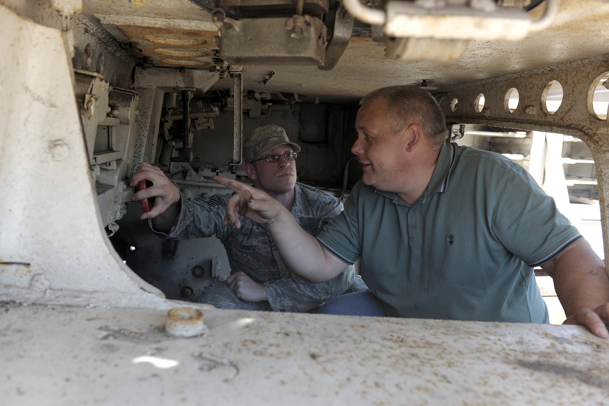 RAF ALCONBURY, United Kingdom – David Tate and Staff Sgt. Adam Rouse, both from the 423rd Civil Engineer Squadron heavy equipment shop, examine the inside of one of only six Tiger I tanks left in the world July 23. The tank was stored at RAF Alconbury during litigation to have it on display at the National Armor and Cavalry Museum at Fort Benning, Ga. Tiger I is a German heavy tank developed in 1942 and used in World War II. (U.S. Air Force photo by Master Sgt. John Barton)