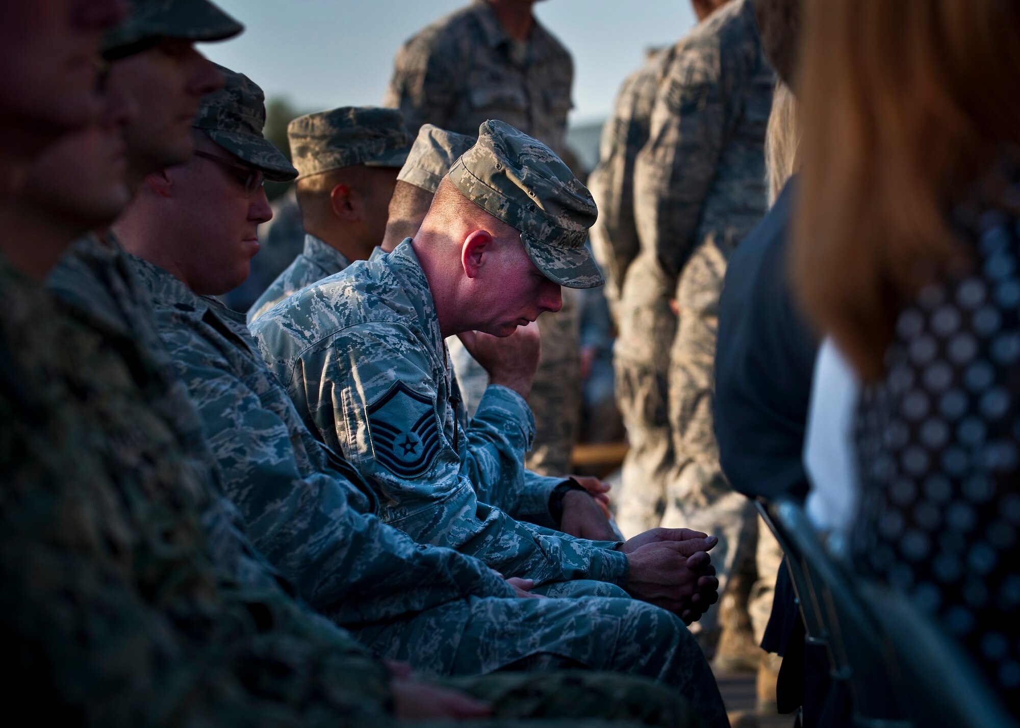 Master Sgt. Michael English bows his head in a moment of silence during the 9/11 remembrance ceremony at the Transit Center at Manas, Kyrgyzstan, Sept. 11, 2012. The moment of silence counsided with the official moment of silence in the U.S. to remember the lives lost during the 9/11 terrorist attacks. English is the 376th Expeditionary Civil Engineer Squadron emergency management flight chief deployed out of Seymour Johnson Air Force Base, N.C. and a native of Washington, Ga. (U.S. Air Force photo/Senior Airman Brett Clashman)