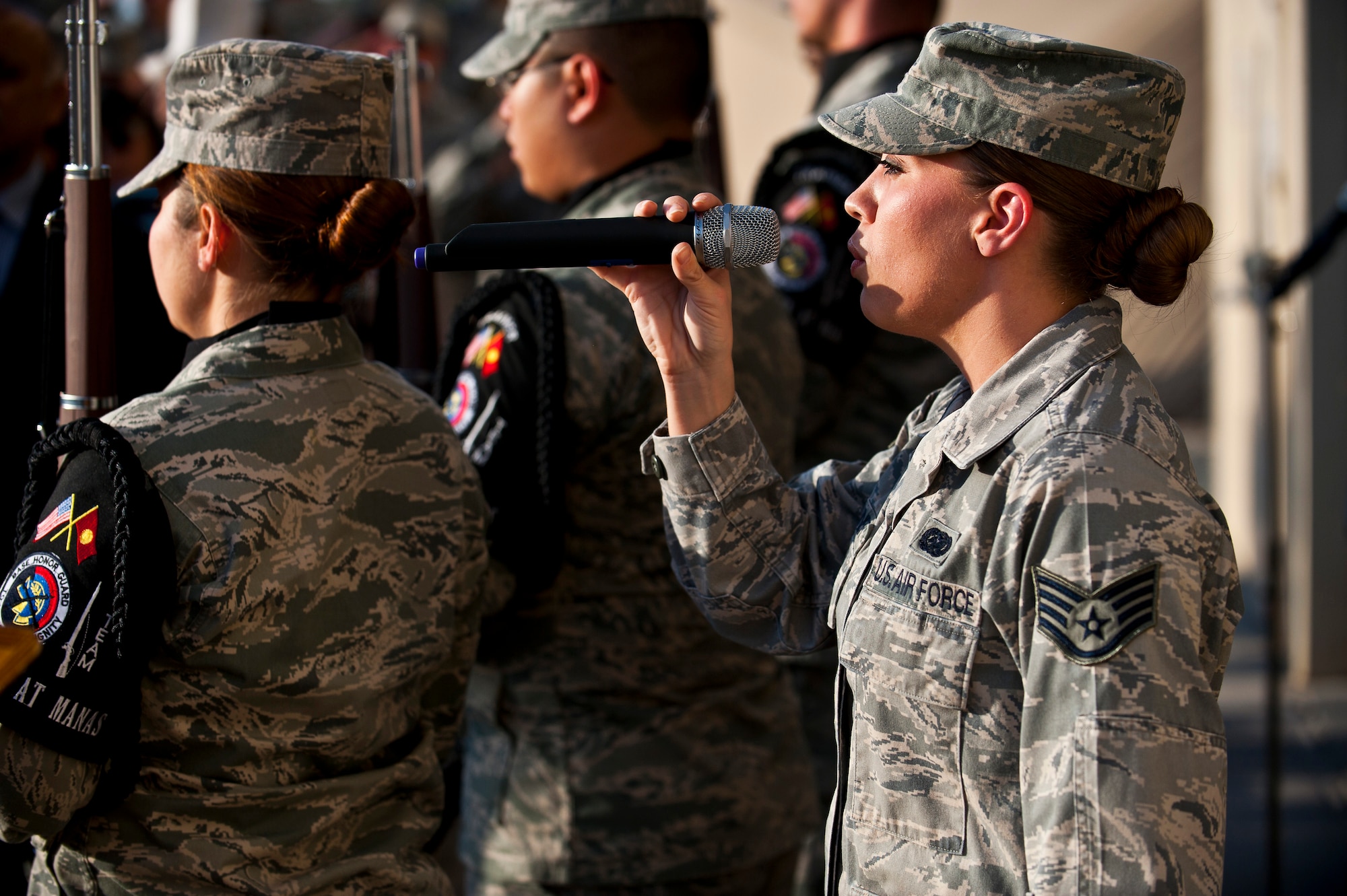 Staff Sgt. Samantha Renner sings the U.S. National Anthem during a 9/11 remembrance ceremony at the Transit Center at Manas, Kyrgyzstan, Sept. 11, 2012. Both the American and Kyrgyz Republic National Anthems were sung at the event. Renner is a 376th Expeditionary Logistics Readiness Squadron resource controller deployed out of Luke Air Force Base, Ariz. and a native of Fremont, Neb. (U.S. Air Force photo/Senior Airman Brett Clashman)