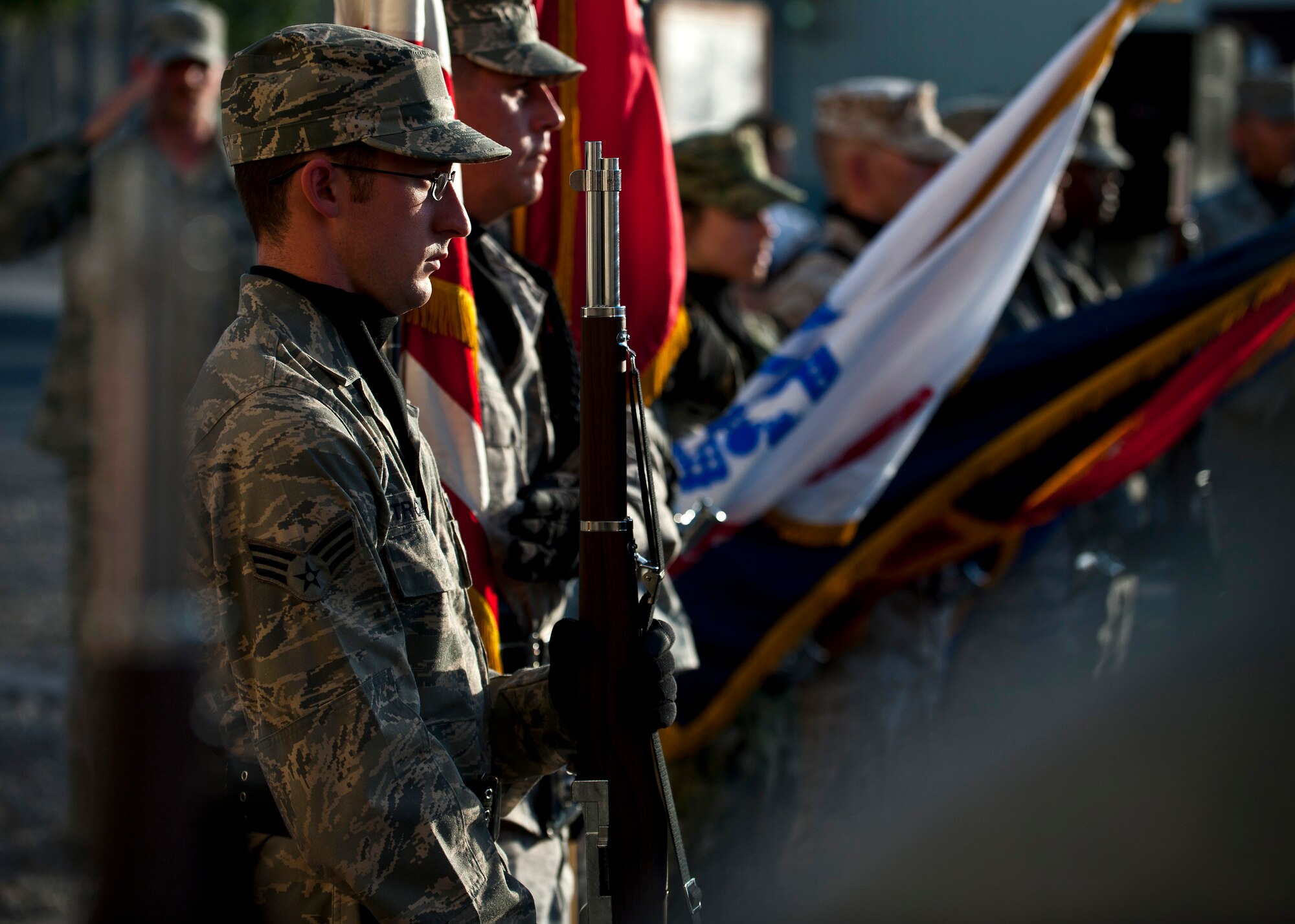Senior Airman Scott Trombley stands at present arms position during the 9/11 remembrance ceremony at the Transit Center at Manas, Kyrgyzstan, Sept. 11, 2012. Service members from Transit Center organizations volunteered to be honor guardsmen during the event. Trombley is a 376th Expeditionary Aircraft Maintenance Squadron aircraft structures and maintenance journeyman deployed out of Fairchild Air Force Base, Wash., and a native of Sheldon, Vt. (U.S. Air Force photo/Senior Airman Brett Clashman)