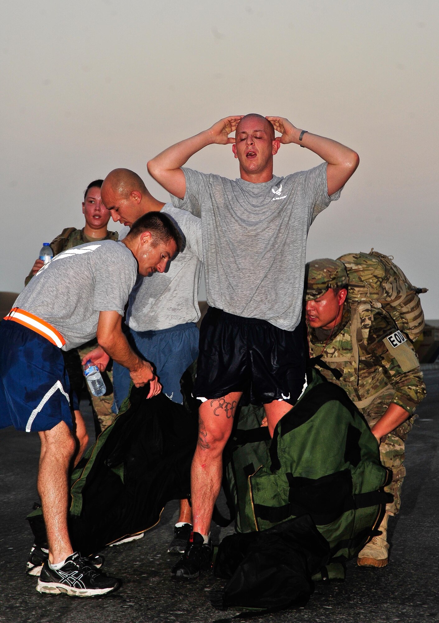 SOUTHWEST ASIA - U.S. Air Force Staff Sgt. Shane Bridges, 380th Expeditionary Civil Engineer Squadron explosive ordinance technician, is assisted with the removal of his bomb suit after he participated in a 9/11 Memorial 5-kilometer walk Sept. 11, 2012. Bridges, who is deployed to the 380th Air Expeditionary Wing from Nellis Air Force Base, Nev., wore the 80-pound suit for the entire walk. (U.S. Air Force photo/Tech. Sgt. Joshua Leach)