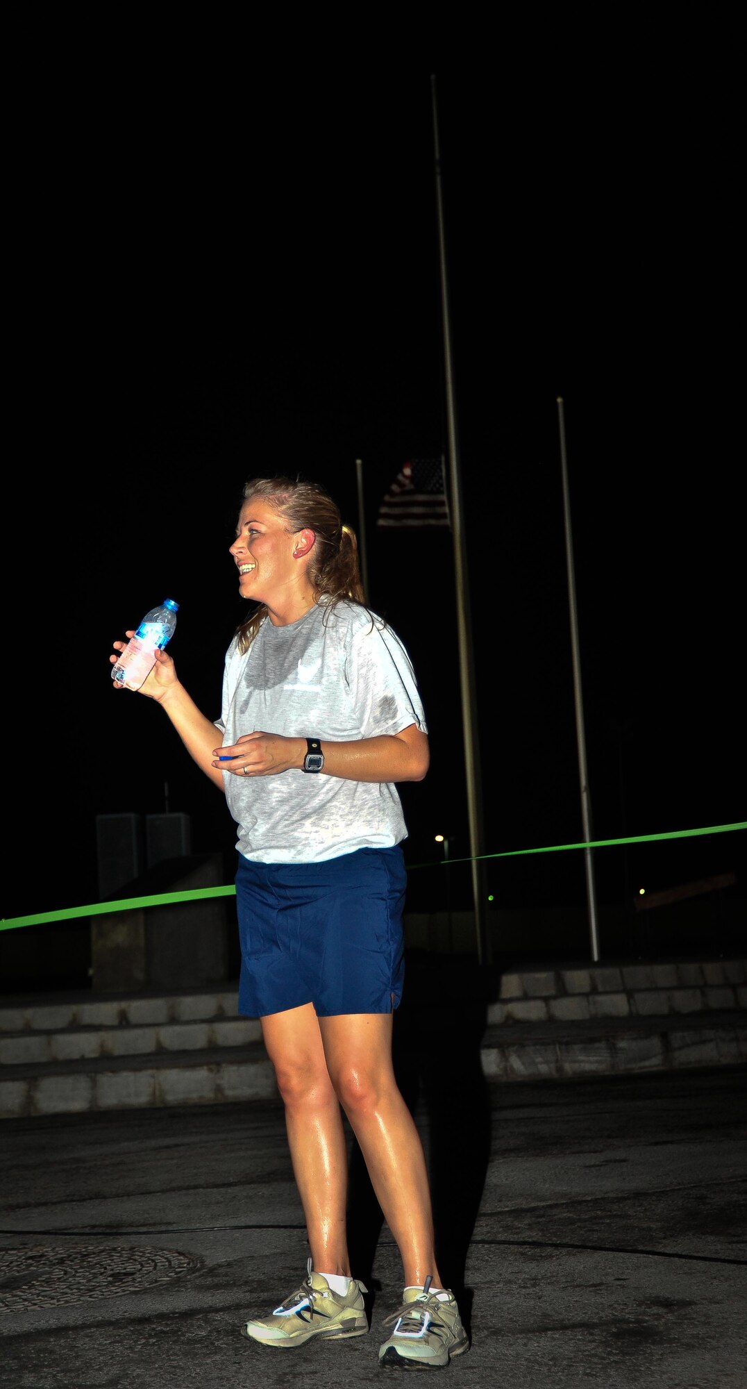 SOUTHWEST ASIA - U.S. Air Force 1st Lt. Alissa Bray, 380th Expeditionary Operations Support Squadron intelligence officer, hydrates after participating in a 9/11 Memorial 5-kilometer run Sept. 11, 2012. Bray is deployed to the 380th Air Expeditionary Wing from Buckley Air Force Base, Colo. (U.S. Air Force photo/Tech. Sgt. Joshua Leach)