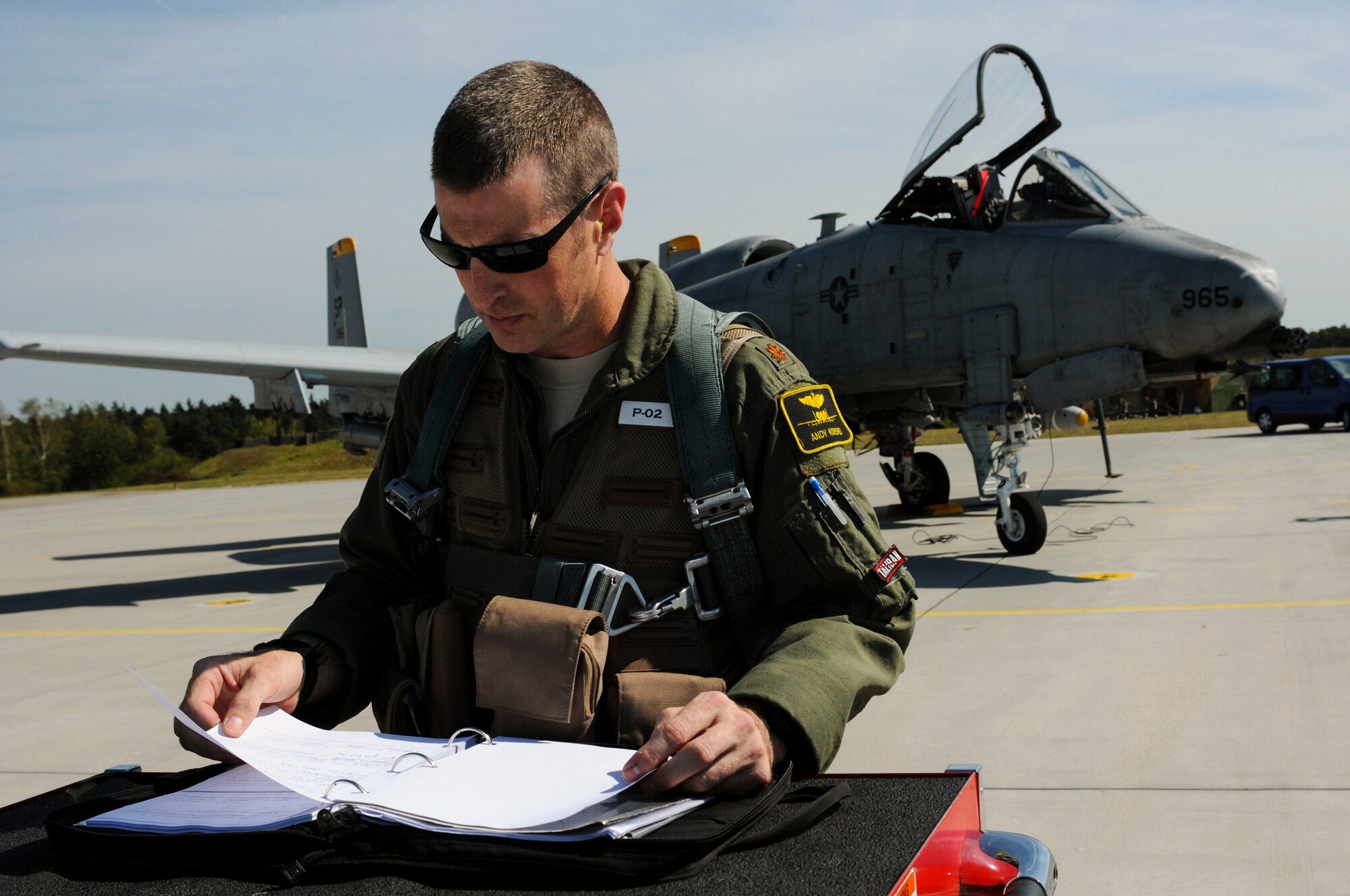 NAMEST AIR BASE, Czech Republic -- Maj. Andy Korsmo, 81st Fighter Squadron A-10 Thunderbolt II pilot, looks over inspection paperwork before taking off for a close air support exercise mission Sept. 10, during Ramstein Rover 2012 here. During this mission the A-10s provided support to German and Italian forward air controllers. RARO12 is a NATO partnership building exercise involving more than 16 nations. A-10 Thunderbolt IIs from the 81st FS are participating in the exercise to provide close air support to partnering nations and practice forward air control missions with their NATO allies in international security assistance force realistic scenarios. Participating in exercises like RARO12 ensures effective employment of airpower in support of alliance or coalition forces while mitigating risks to civilians in contingency operations. (U.S. Air Force photo by Senior Airman Natasha Stannard/Released)