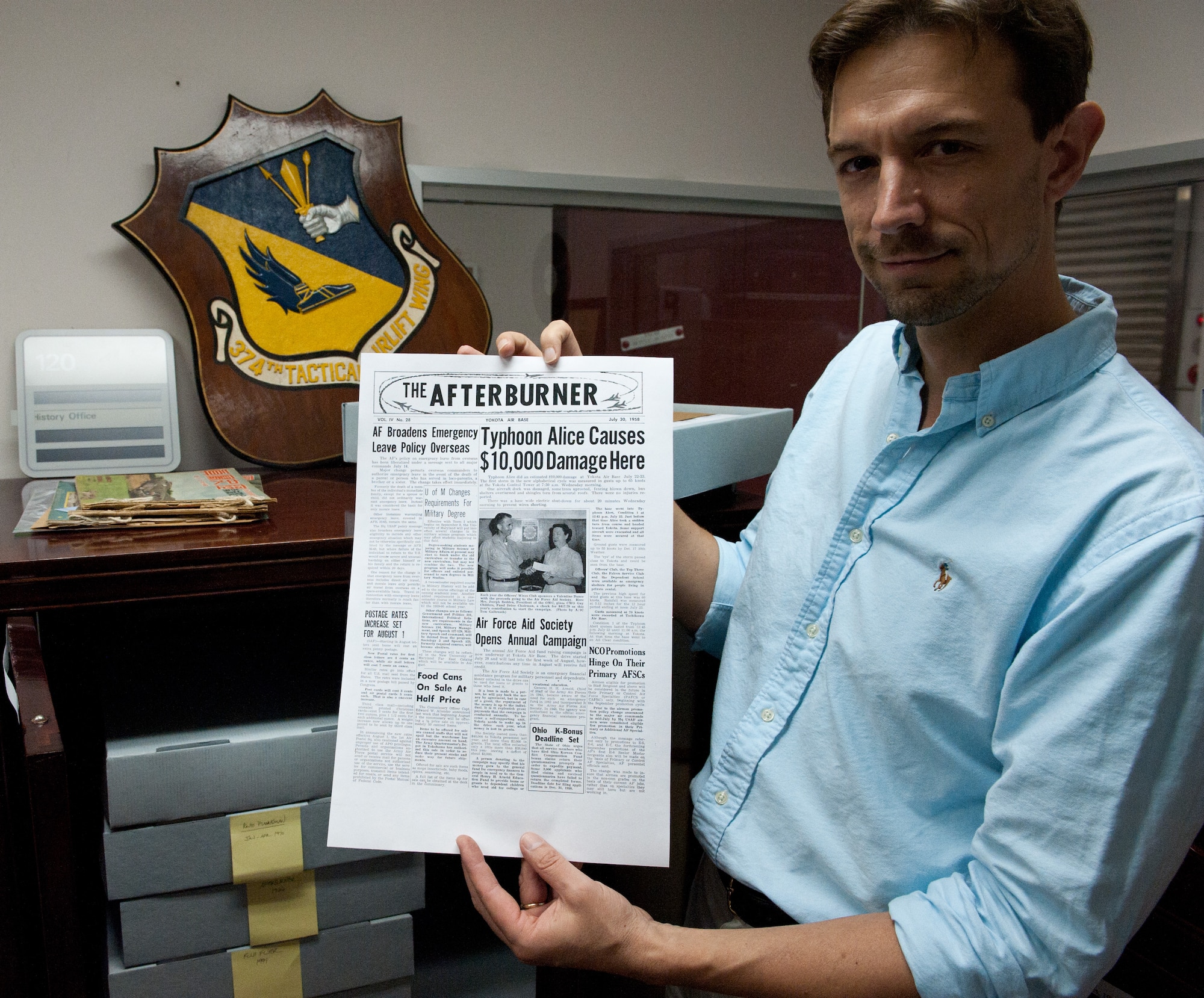 YOKOTA AIR BASE, Japan -- Dr. John Treiber, 374th Airlift Wing historian, holds a photocopy of the newspaper, The Afterburner, at Yokota Air Base, Japan, on Sept. 12, 2012. Yokota began carring a base newspaper in the mid 1940s, and the newspaper was later renamed the Fuji Flyer in July 1970. (U.S. Air Force photo by Airman 1st Class John D. Partlow)
