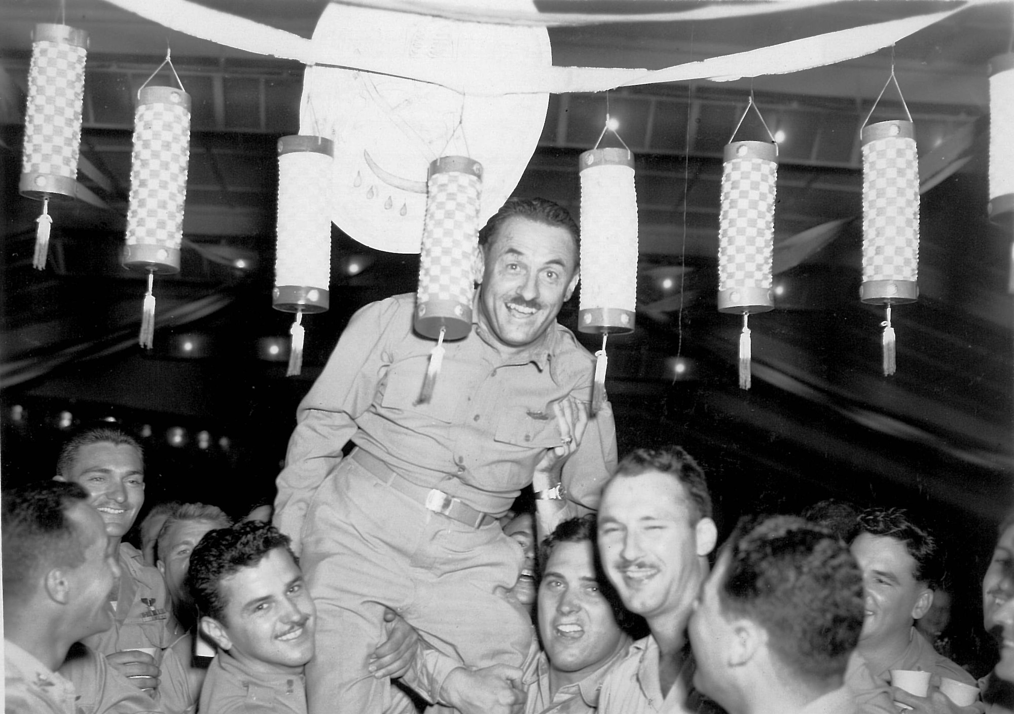 YOKOTA AIR BASE, Japan -- Yokota Army Air Base commander Col. Edwin Bobzien, center, attends at a party at the Yokota Officers' Club circa August 1946. Bobzien died two months after the photo was taken in a B-29 Superfortress crash. Bobzien Avenue, now known as Airlift Avenue, was named after him, and a street on the west side of base still carries his name. (Photo from the collection of Father Frank Mathy, courtesy of the 374 AW History Office) 