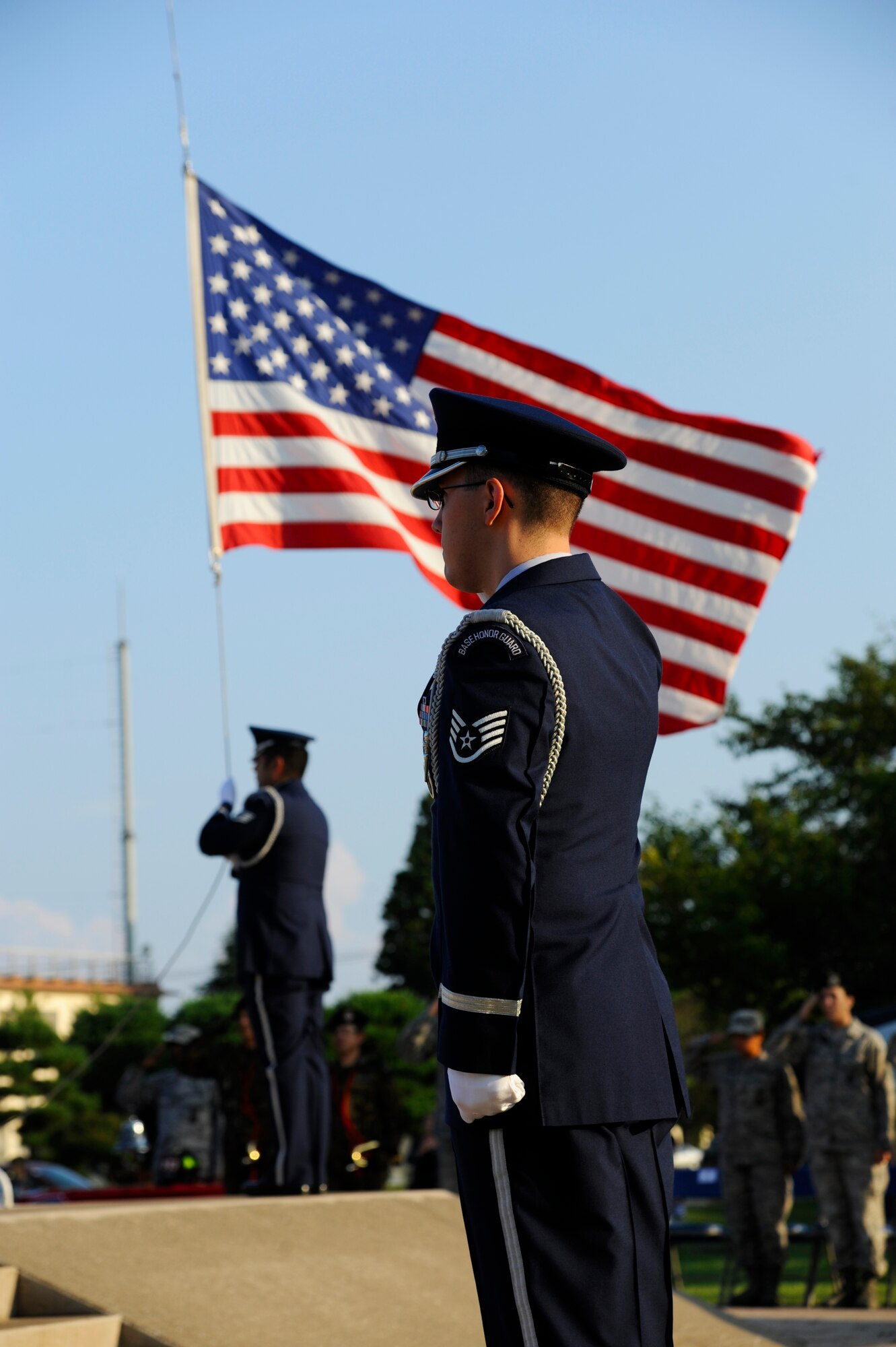 A member of the base honor guard renders a salute during the Patriot Day Retreat Ceremony at Misawa Air Base, Japan, Sept. 11, 2012. The ceremony served as a time to honor the victims and first responders in the 9/11 terrorist attacks. (U.S. 
Air Force photo by Staff Sgt. April Quintanilla/Released)
