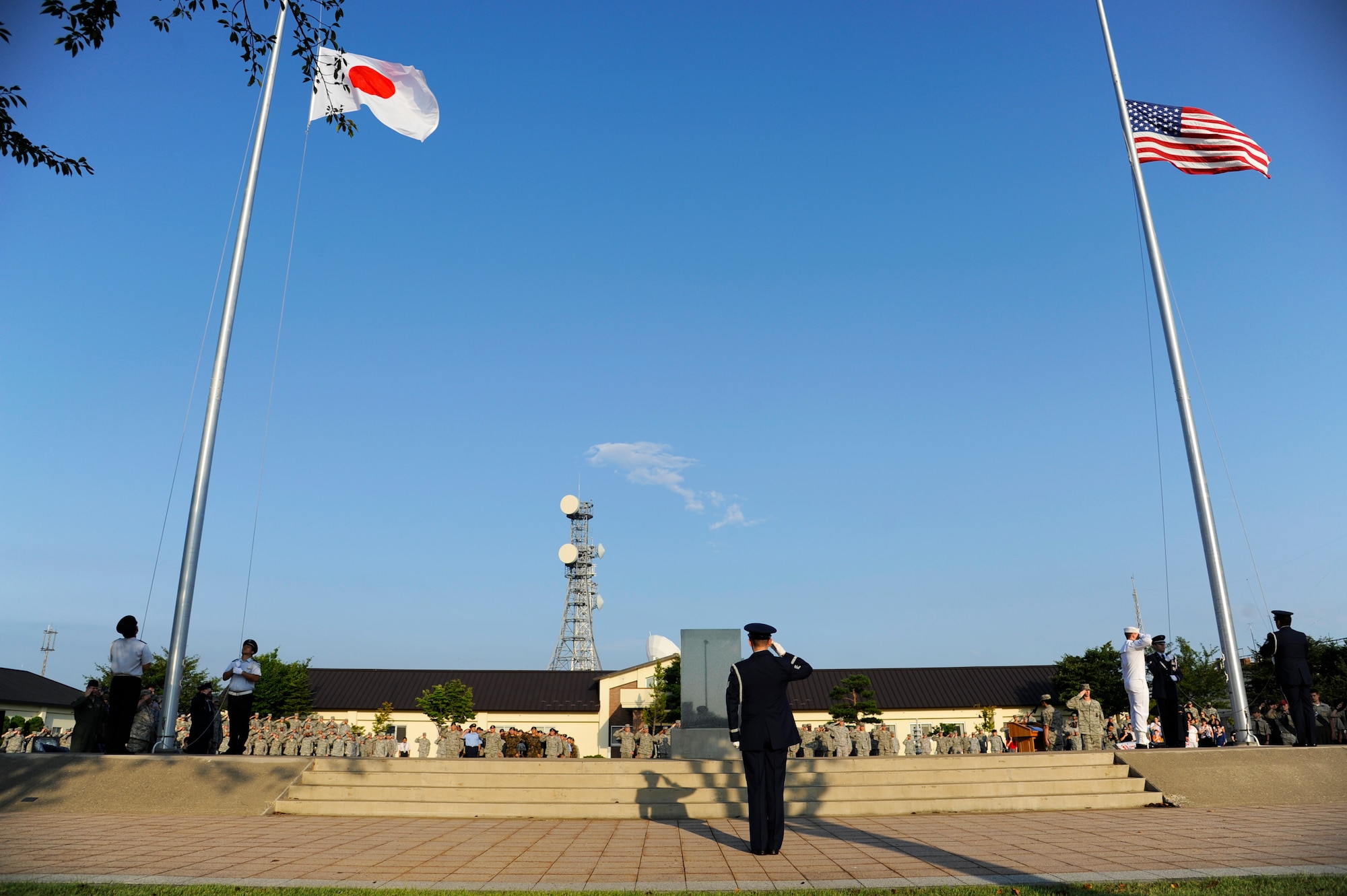 Members of the base and Japan Air Self-Defense Force honor guards lower the flags during the Patriot Day Retreat Ceremony at Misawa Air Base, Japan, Sept. 11, 2012. The 35th Fighter Wing held a retreat ceremony to honor and remember those who were affected by the tragic events that occurred 11 years ago. (U.S. Air Force photo by Staff Sgt. April Quintanilla/Released)
