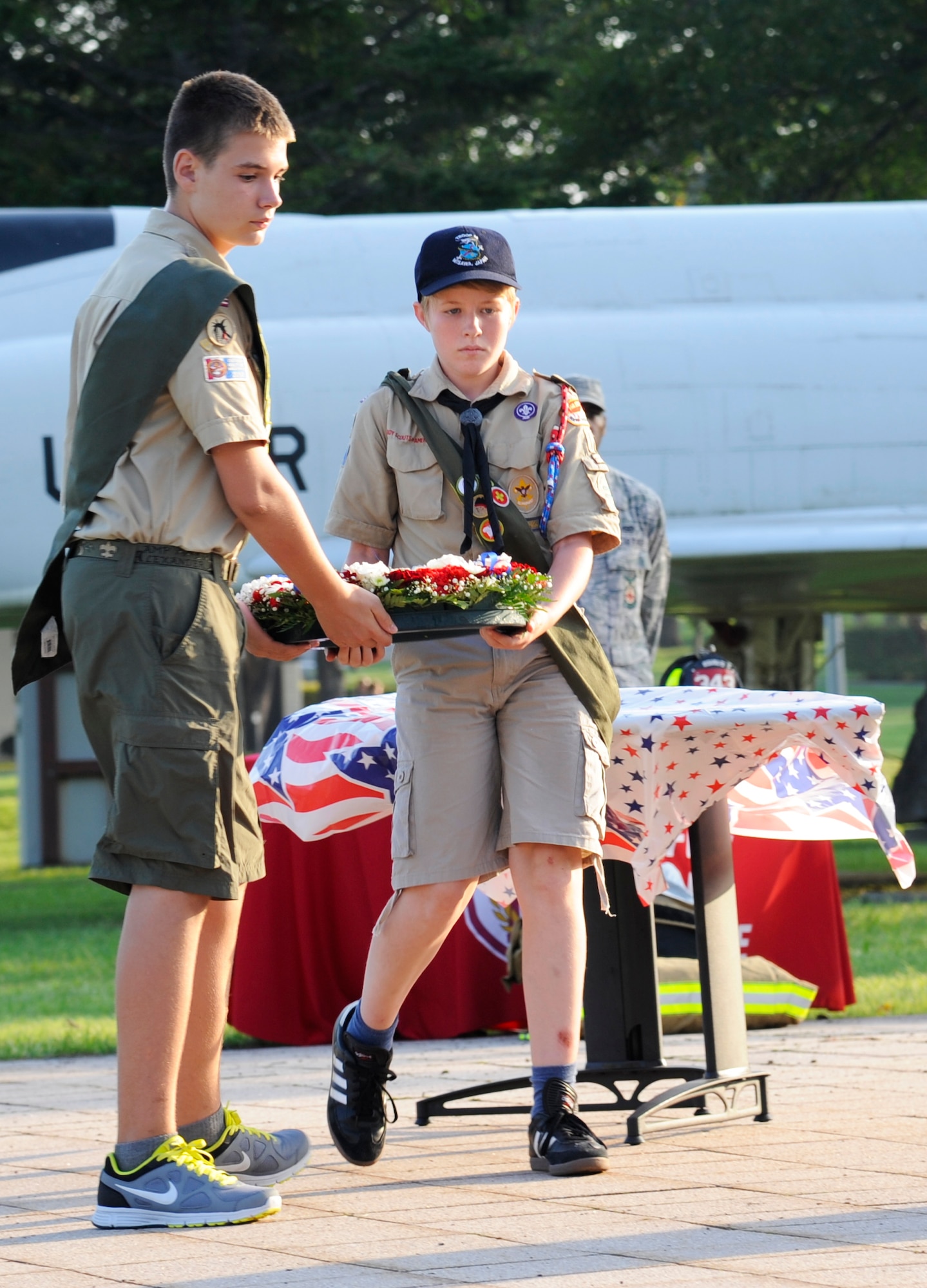 Members of the Boy Scouts of America carry a commemorative wreath to the base flag pole during the Patriot Day Retreat Ceremony at Misawa Air Base, Japan, Sept. 11, 2012. The memory of those who were lost on September 11, 2001 was honored with the laying of a commemorative wreath and ringing of the "last alarm," followed by a moment of silence and the playing of taps. (U.S. Air Force photo by Staff Sgt. April Quintanilla/Released)

