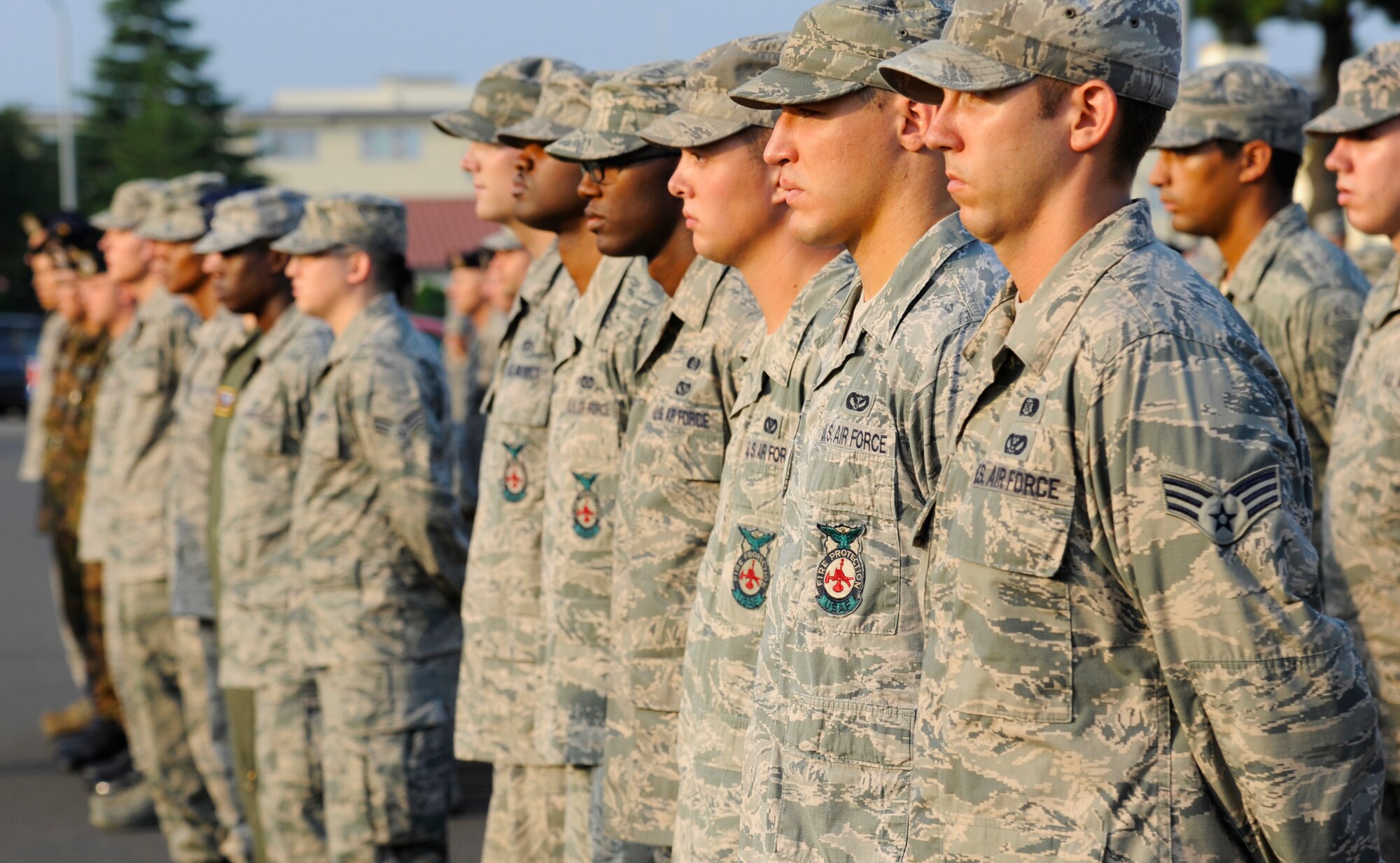 Airmen with the 35th Security Forces Squadron, 35th Civil Engineer Squadron and 35th Medical Group stand in formation at the base flag pole during the Patriot Day Retreat Ceremony at Misawa Air Base, Japan, Sept. 11, 2012. Members of the 
Misawa Air Base community gathered to watch the ceremony and honor those who were affected by the attacks on Sept. 11, 2001. (U.S. Air Force photo by Staff Sgt. April Quintanilla/Released)
