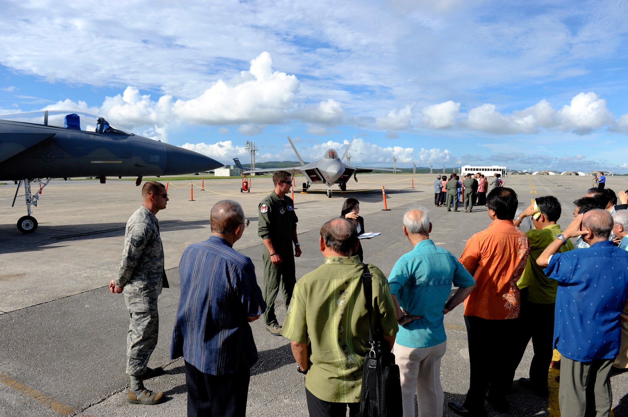 Honorary commanders visiting Kadena Air Base, Japan, as part of the Honorary Commander orientation tour talk with a 44th Fighter Squadron F-15C Eagle and Joint Base Langley-Eustis F-22 Raptor pilots on the Kadena flightline Sept. 7, 2012. The event was held as part of the Honorary Commander program, which is designed to build a better relationship and reinforce ties between the U.S. military and the community as well as give commanders the opportunity to showcase the 18th Wing mission. (U.S. Air Force photo/ Senior Airman Maeson L. Elleman)