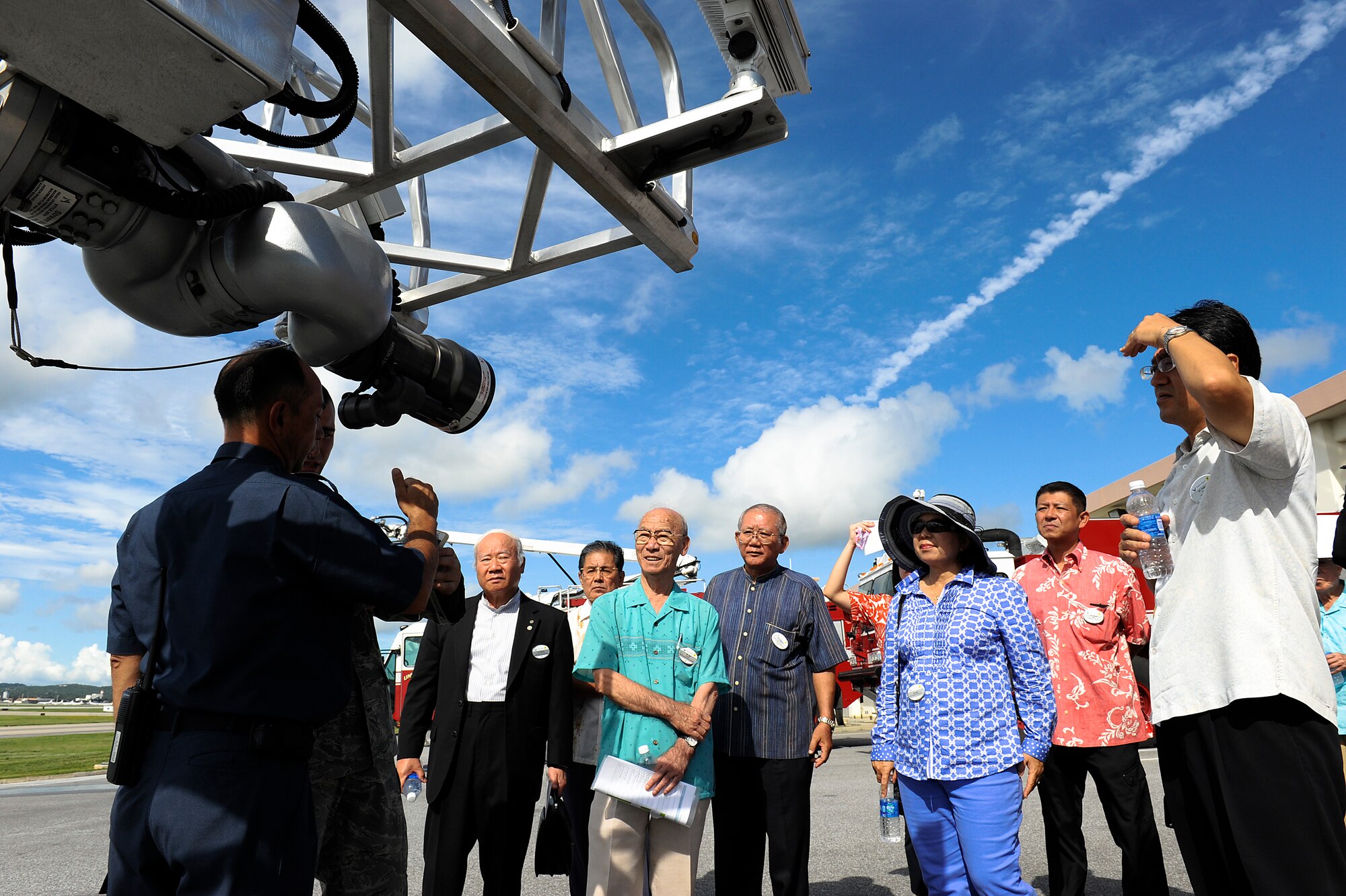 Kenichi Shimajiri, 18th Civil Engineer Squadron firefighter, shows local Okinawan leaders and honorary commanders a U.S. Air Force fire truck during the Honorary Commander orientation tour at the fire station on Kadena Air Base, Japan, Sept. 7, 2012. The event was held as part of the Honorary Commander program, which is designed to build a better relationship and reinforce ties between the U.S. military and the community as well as give commanders the opportunity to showcase the 18th Wing mission. (U.S. Air Force photo/ Senior Airman Maeson L. Elleman)