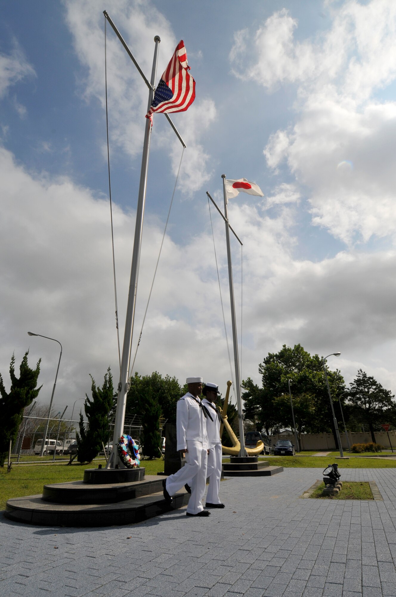 Chief (select)Aviation Boatswain's Mate (Handling) Shawn Leigh, foreground, from Norfolk, and Chief (select) Logistics Specialist Nicola Canada, a native of Lexington, Ky., march away from the U.S. flagpole after laying a commemorative wreath during a 9/11 Remembrance Ceremony onboard Naval Air Facility Misawa, Japan, Sept. 11, 2012.  Navy Misawa chief petty officer selectees conducted the ceremony to commemorate the 11th anniversary of the Sept. 11, 2001 terrorist attacks. (U.S. Navy photo by Mass Communication Specialist 2nd Class Pedro A. Rodriguez/RELEASED)
