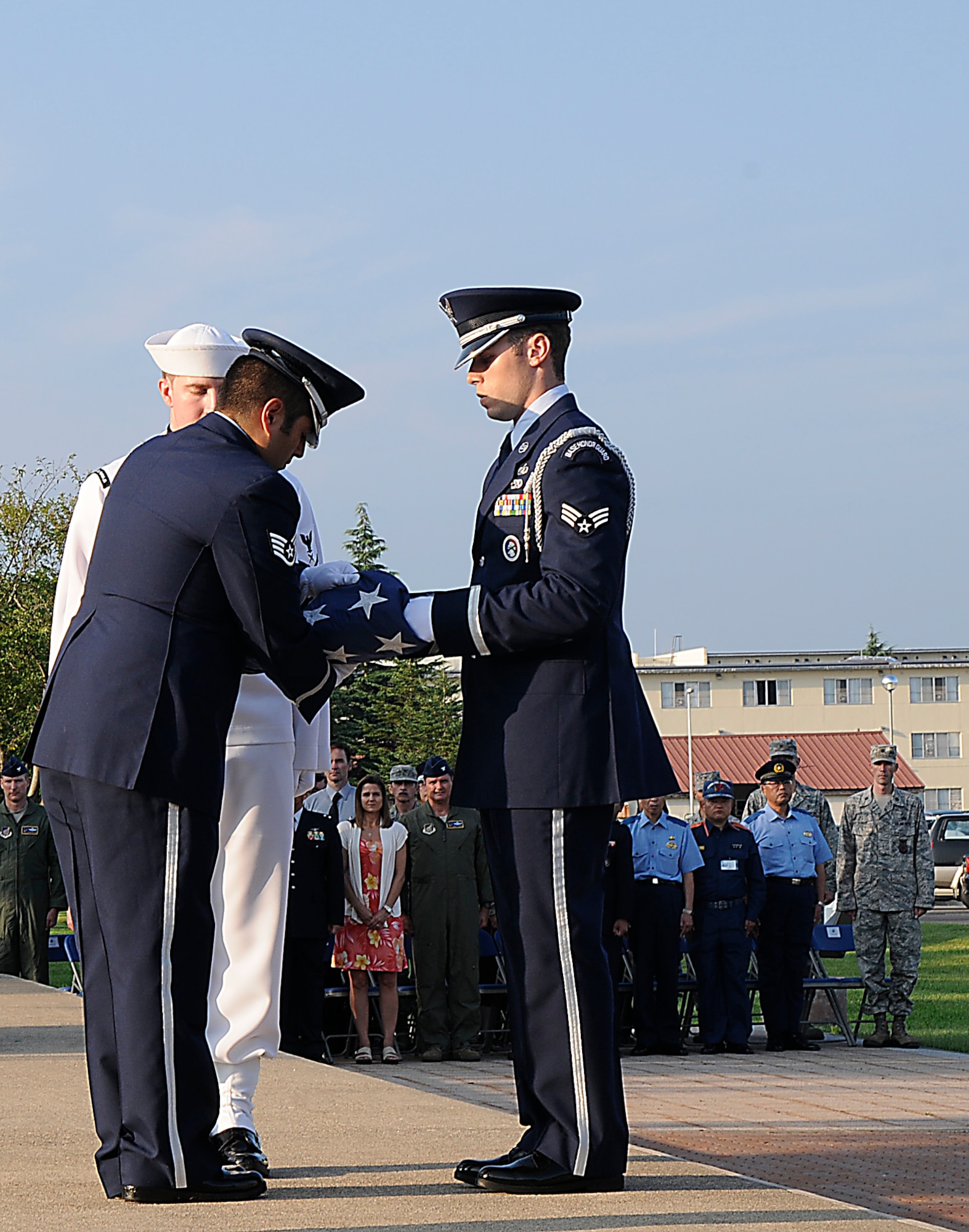 Members of the base honor guard fold the American Flag at a retreat ceremony on Sept. 11, 2012 at Misawa Air Base, Japan. People gathered to watch the ceremony and honor those who were affected by the attacks on Sept. 11, 2001. (U.S. Air Force photo by 2nd Lt. Son Lee/Released)