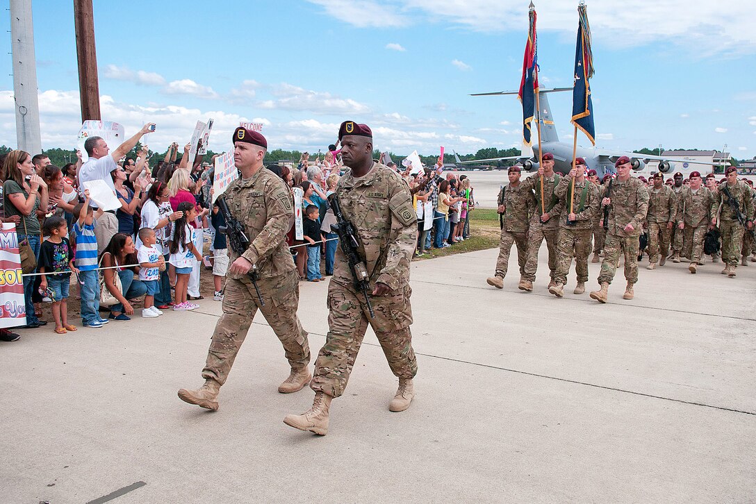 Army Col. Mark L. Stock, left, and Army Command Sgt. Maj. Joey Love lead paratroopers assigned to the 82nd Airborne Division's 1st Brigade Combat Team past awaiting families at Pope Army Airfield on Fort Bragg, N.C., Sept. 9, 2012.
