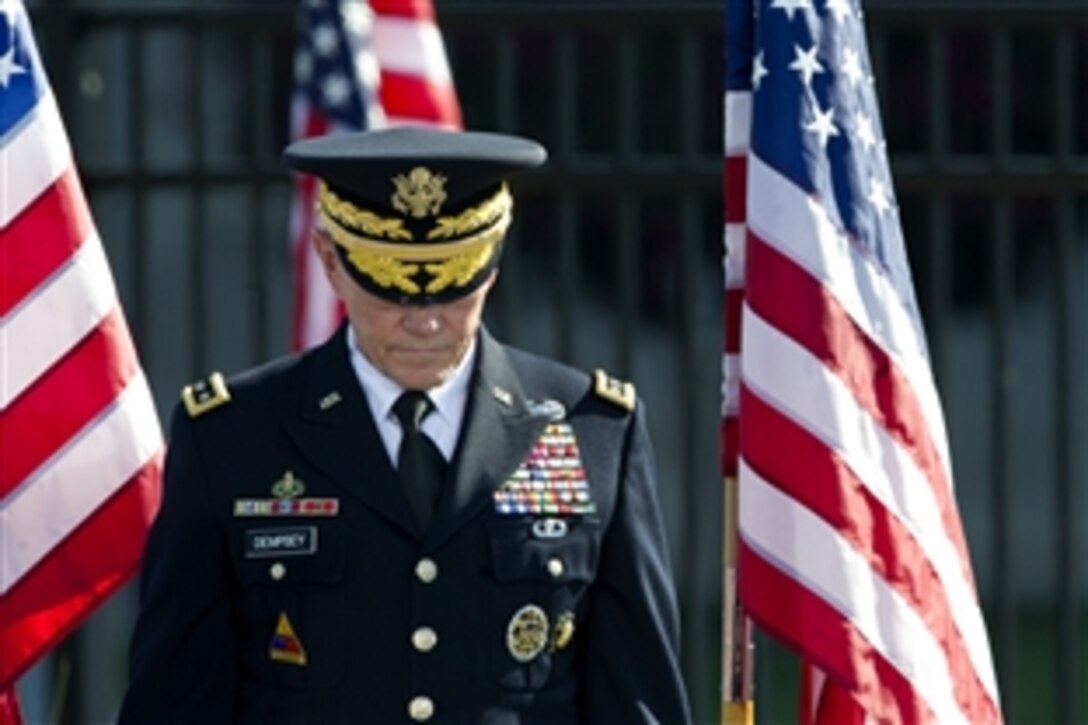 Army Gen. Martin E. Dempsey, chairman of the Joint Chiefs of Staff, bows his head for an invocation during a ceremony to commemorate the 9/11 terrorist attacks at the Pentagon, Sept. 11, 2012.