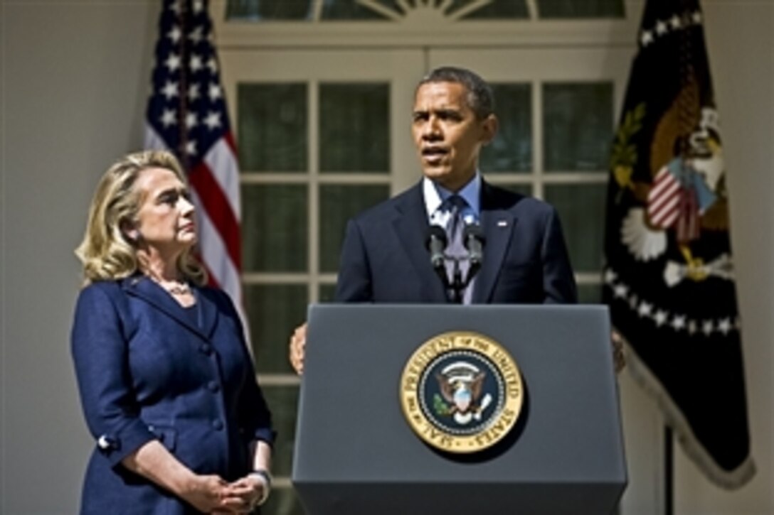 President Barack Obama delivers a statement regarding the attack on the U.S. consulate in Benghazi, Libya, as Secretary of State Hillary Rodham Clinton looks on at the White House, Sept. 12, 2012.