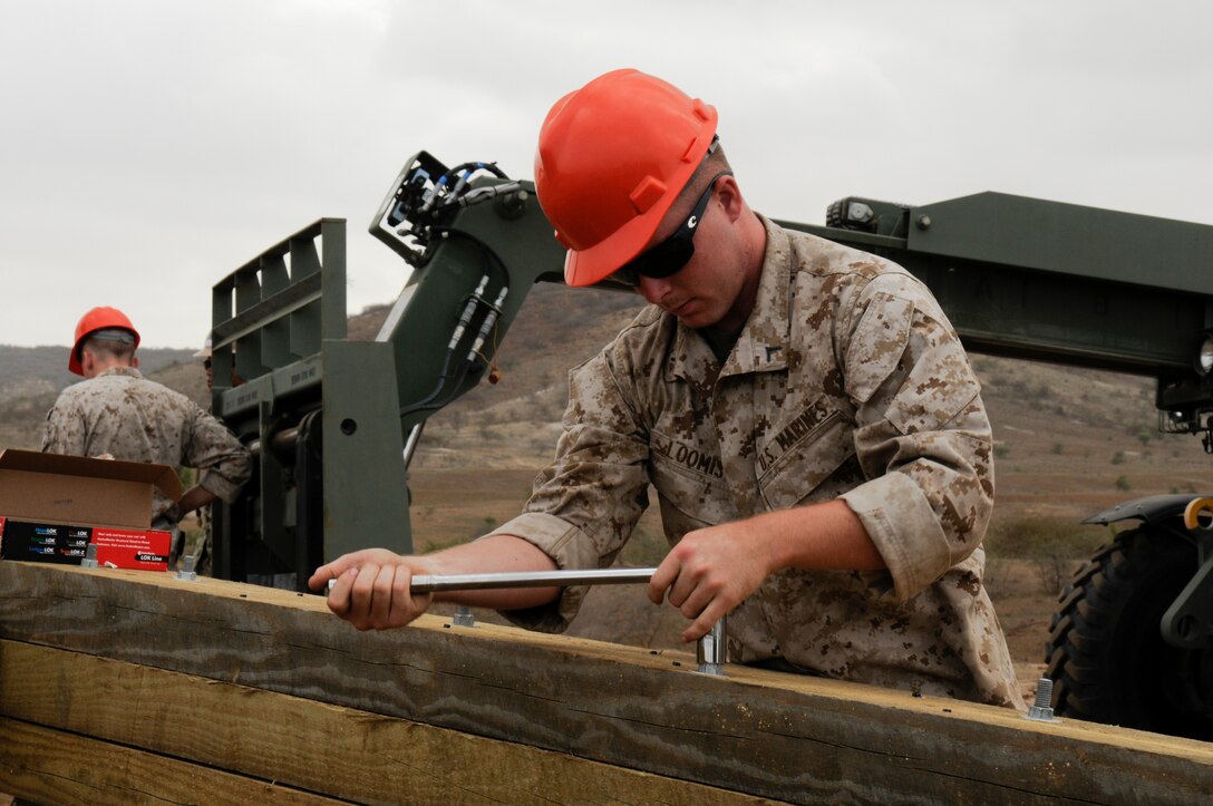 U.S. Marine Lance Cpl. Kolton Loomis, a combat engineer with the Marine Wing Support Squadron 473, tightens lug nuts on a watchtower he is helping construct in Thies, Senegal, July 11, 2012. Loomis is participating in Western Accord 2012, a multi-lateral exercise with Senegalese, several Western African nations and the Armed Forces of Burkina Faso, Guinea, Gambia and France.