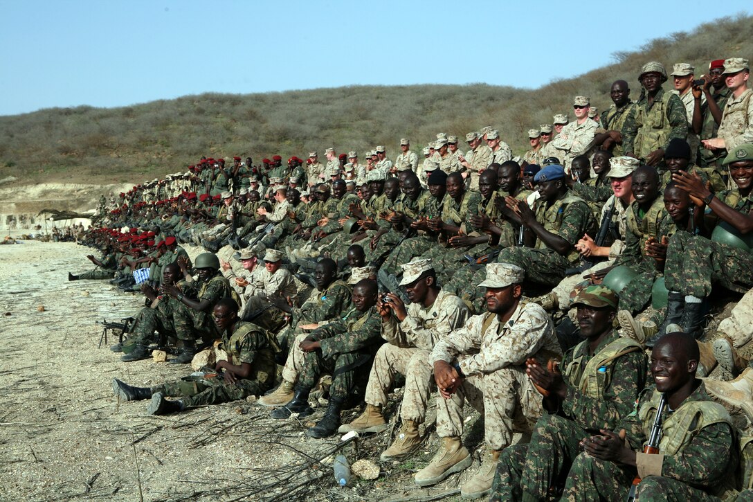 A contingent of U.S., Senegalese, Burkina Faso, Gambia, Guinea and French Marines, soldiers, sailors and airmen from Exercise Western Accord 2012 watch a demonstration for a distinguished visitor’s day. Exercise Western Accord 2012 is a multi-lateral training exercise with West African nations to increase understanding and interoperability, prevent conflict by enabling Africans to provide for their security and stability, strengthen relationships with partner nations, and promote and support U.S. national security priorities. Participating nations include the U.S., Senegal, Gambia, Guinea, Burkina Faso and France.