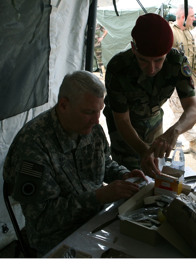 After a demonstration for distinguished visitors, U.S. Marines celebrate with Gambian soldiers in a native, tribally-influenced dance and song. Exercise Western Accord 2012 is a multi-lateral training exercise with West African nations to increase understanding and interoperability, prevent conflict by enabling Africans to provide for their security and stability, strengthen relationships with partner nations, and promote and support U.S. national security priorities. Participating nations include the U.S., Senegal, Gambia, Guinea, Burkina Faso and France.