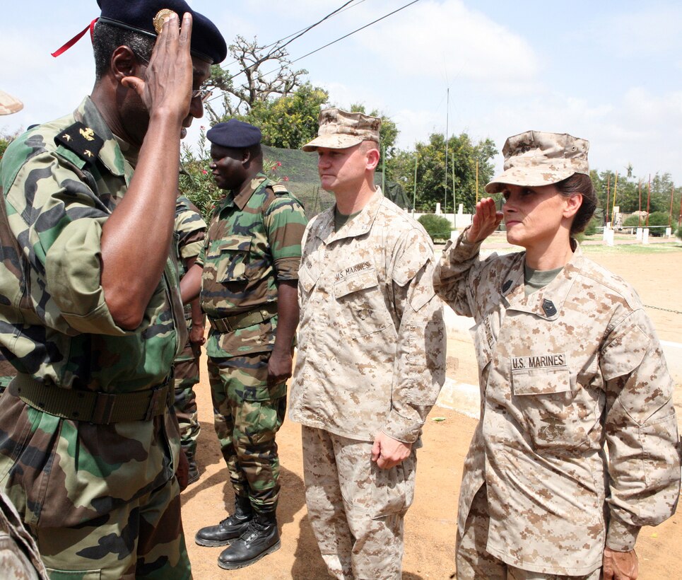 During a visit from distinguished guests, Master Gunnery Sgt. Teresa J. Cardwell, the personnel officer for Exercise Western Accord 2012 and Seymour, Mo., native, salutes Senegalese Admiral Ousmane Ibrahima Sall, Deputy Chief of Staff of the Armed Forces of Senegal, as a contingent of U.S. Marines, soldiers, sailors and airmen meet-and-greet with visitors from the U.S. Embassy, Senegal, Gambia, France, Guinea and Burkina Faso. Distinguished visitors included: Gen. Carter F. Ham, the commander of U.S. Africa Command; Lt. Col. Daniel Jones, U.S. Defense Attaché to Senegal; Col. Douglas Fairfeld, Chief of Staff for U.S. Marine Corps Forces Africa; The Honorable Robert Yamate, Charge d’Affairs of the U.S. Embassy in Dakar; Brig. Gen. Richard N. Harris Jr., Chief of Joint Staff of the Vermont Air National Guard; Admiral Ousmane, Ibrahima Sall, Deputy Chief of Staff of the Armed Forces of Senegal; Brig. Gen. Pape Samba Kamara, Chief of the Senegalese army; Brig. Gen. Gregoire Saint-Quentin, Commander, French Elements in Senegal; Col. Vinta Some, Burkina Faso Contingent Commander, ECOWAS Standby Force; Mr. Abdoulie Kah, Deputy Permanent Secretary of Ministry of Defense, Gambia; Brig. Gen. Namory Traore, Deputy Chief of Staff of the Armed Forces, Guinea. Exercise Western Accord 2012 is a multi-lateral training exercise with West African nations to increase understanding and interoperability, prevent conflict by enabling Africans to provide for their security and stability, strengthen relationships with partner nations, and promote and support U.S. national security priorities. Participating African nations include Senegal, Burkina Faso, Guinea, and Gambia.