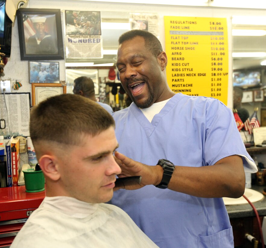 Darryl E. Leach, the owner of a local barber in Jacksonville, gives a haircut to Lance Cpl. Hayden Brown, a telephone systems and personal computer intermediate repairer with 2nd Intelligence Battalion at a barbershop in Jacksonville, N.C., Sept. 9. Leach greets service members with an infectious, upbeat and outgoing personality. After completing his active-duty service with the Navy he became a barber and worked in Philadelphia, but he returned to the crystal coast to serve those who serve in the military.