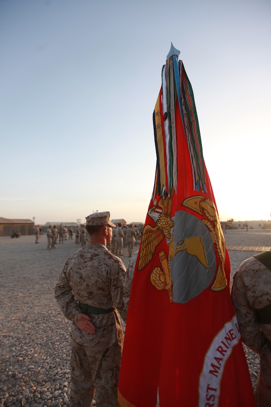 Cpl. Justin Barlock, a member of the Combat Logistics Regiment-15 color guard, stands at parade rest before the start of a transfer of authority ceremony from 1st Marine Logistics Group (Forward) to CLR-15, Sept. 10. The ceremony represented a change in leadership. More importantly though, it symbolized continuity in the steadfast support provided by the Marines and sailors of the logistics combat element.