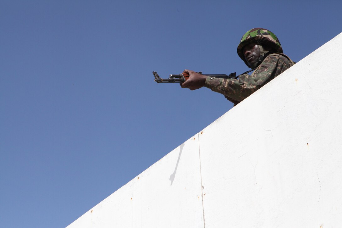 A member of the Gambian army participating in Exercise Western Accord 2012, practices clearing a rooftop at urban combat techniques training, July 13. U.S. service members, primarily Reservists from the Marines, Army, Navy, and Air Force are taking part in WA-12 -- a multi-lateral exercise with Senegalese and several Western African nations. The training exercise runs from June 26 - July 24 and involves Armed Forces of Senegal, Burkina Faso, Guinea, Gambia and France.
