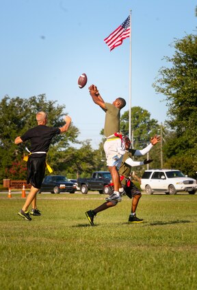 Marines and sailors with 2nd Battalion, 8th Marine Regiment, compete in a flag football game as part of the 2/8 Olympics. The unit gave their weathered camouflage utilities a week-long break to carry out a battalion size Olympics promoting unit cohesion and competitive spirits.
