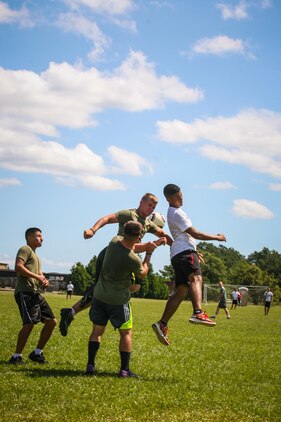 Marines and sailors with 2nd Battalion, 8th Marine Regiment, compete in a soccer game as part of the 2/8 Olympics. The unit gave their weathered camouflage utilities a week-long break to carry out a battalion size Olympics promoting unit cohesion and competitive spirits.