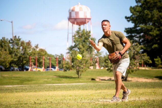Lance Cpl. Jacob Fransisco of Taylorsville, N.C., and a team leader with 2nd Battalion, 8th Marine Regiment, pitches a softball during a 2/8 Olympics softball game. The battalion gave their weathered camouflage utilities a week-long break to carry out a battalion size Olympics promoting unit cohesion and competitive spirits.