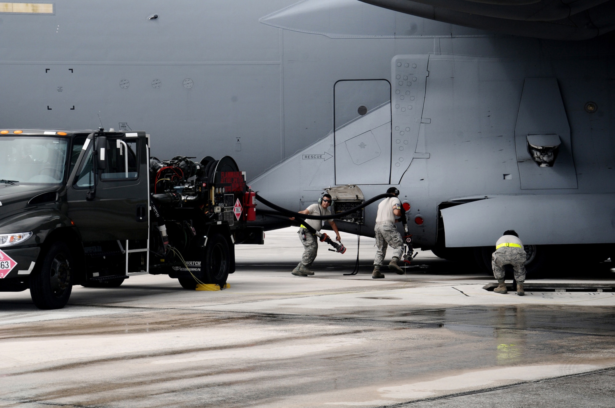 ANDERSEN AIR FORCE BASE, Guam—Servicemembers work together to fuel an aircraft on the flightline here, Sept. 7. Team Andersen fuels some of the United States largest joint and coalition exercises in the Asia-Pacific region. (U.S. Air Force photo by Airman 1st Class Mariah Haddenham/Released)