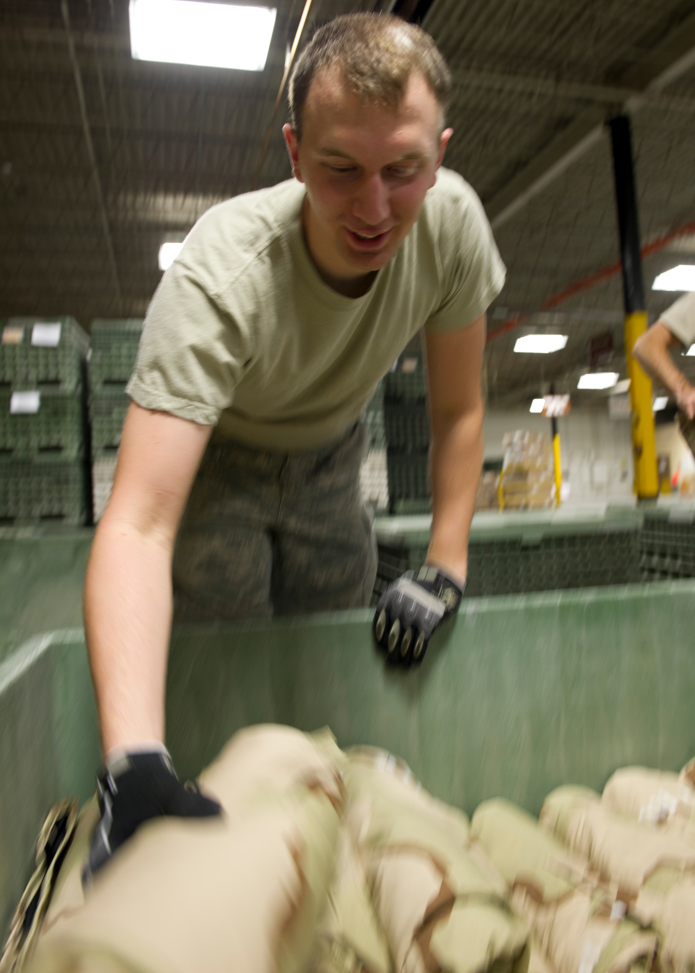 Airman 1st Class Michael Brown, 49th Logistics Readiness Squadron individual protective equipment journeyman, places Mission Oriented Protective Posture gear in a bin at Holloman Air Force Base, N.M., Sept. 12. Brown is one of three Airmen tasked to inventory all of the MOPP gear in preparation for a training exercise. (U.S. Air Force photo by Senior Airman Kasey Close/Released)