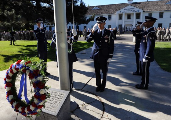Team Fairchild Honor Guard members salute the flag during a 9/11 retreat ceremony commemorating the anniversary of the terrorist attacks on America. The retreat ceremony was held in front of the headquarters building at Fairchild Air Force Base, Wash. Sept. 11, 2012. (U.S. Air Force photo by Senior Airman Benjamin Stratton)