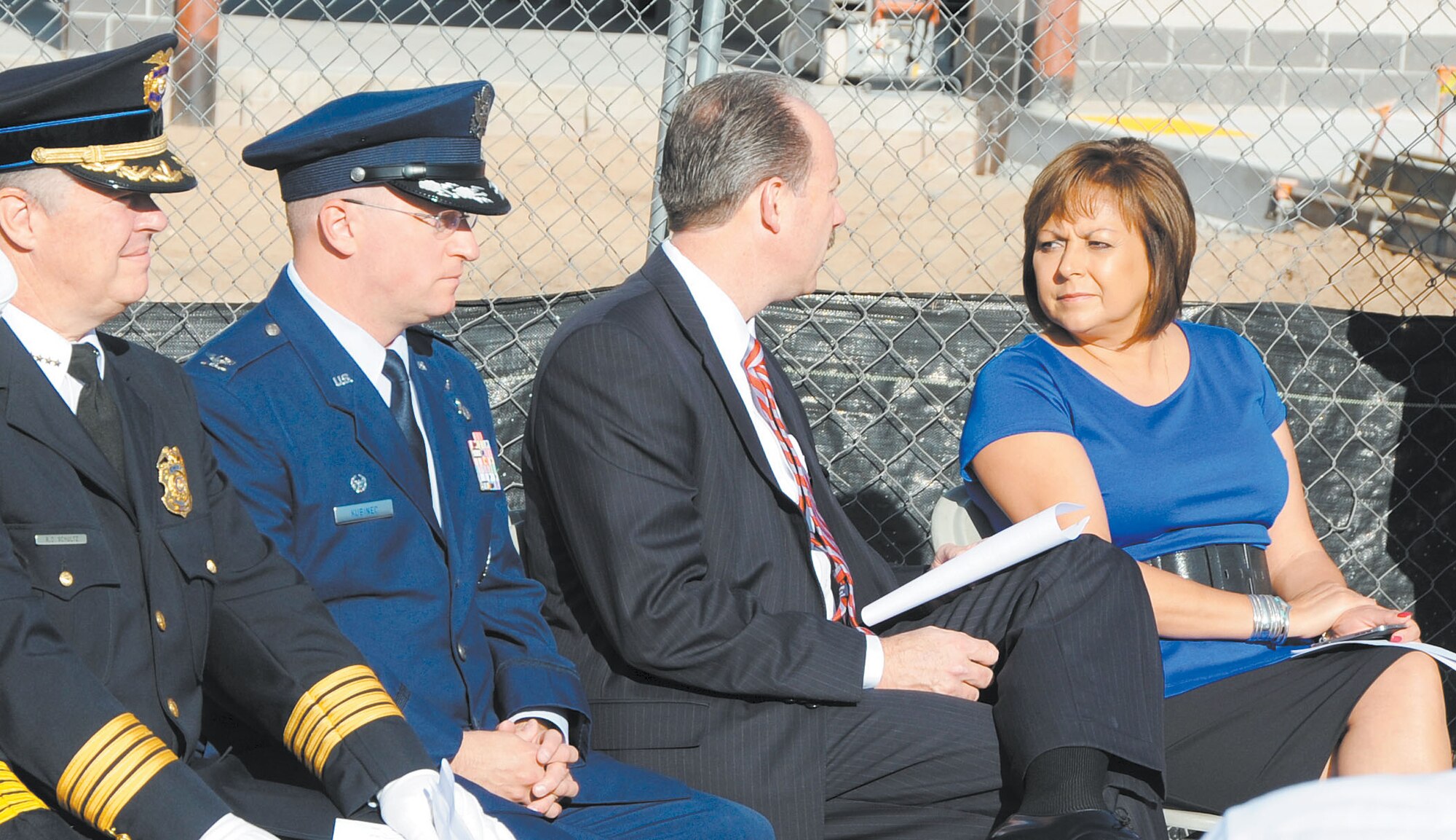 KIRTLAND AFB, N.M. -- Albuquerque Police Chief Ray Schultz, Col. John Kubinec, 377th Air Base Wing commander, Albuquerque Mayor Richard Berry and New Mexico Governor Susana Martinez take their seats before a 9/11 ceremony Tuesday.  To coincide with the theme “Rebuilding for the Future,” the ceremony was held at the Fire Station 2 construction site. (Photo by Dennis Carlson)