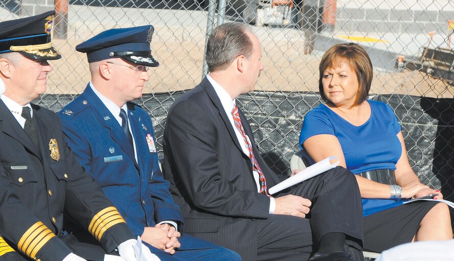 KIRTLAND AFB, N.M. -- Albuquerque Police Chief Ray Schultz, Col. John Kubinec, 377th Air Base Wing commander, Albuquerque Mayor Richard Berry and New Mexico Governor Susana Martinez take their seats before a 9/11 ceremony Tuesday.  To coincide with the theme “Rebuilding for the Future,” the ceremony was held at the Fire Station 2 construction site. (Photo by Dennis Carlson)