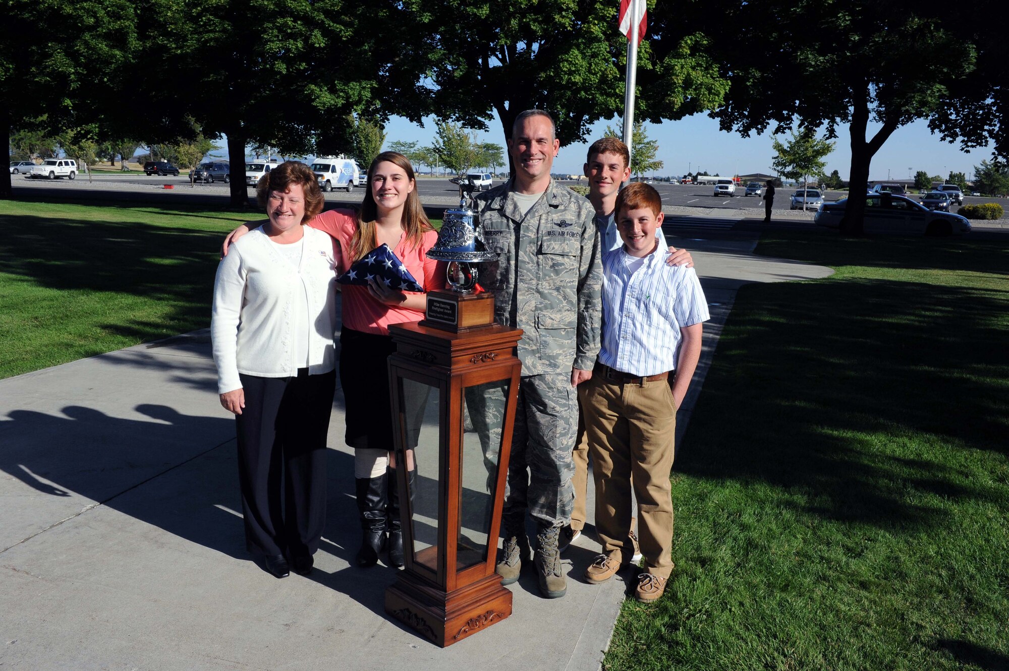 Jessica Davidson, 2012 Lewis and Clark High School graduate from Spokane, Wash., poses for a photo with Col. Brian Newberry, 92nd Air Refueling Wing commander, and his family during her visit at Fairchild Air Force Base, Wash., Sept. 11, 2012. Davidson was invited by Newberry for her work sending care packages to servicemembers deployed to the U.S. military’s Central Command. The colonel was one Airman who received a gift from home. (U.S. Air Force photo by Staff Sgt. Michael Means)
