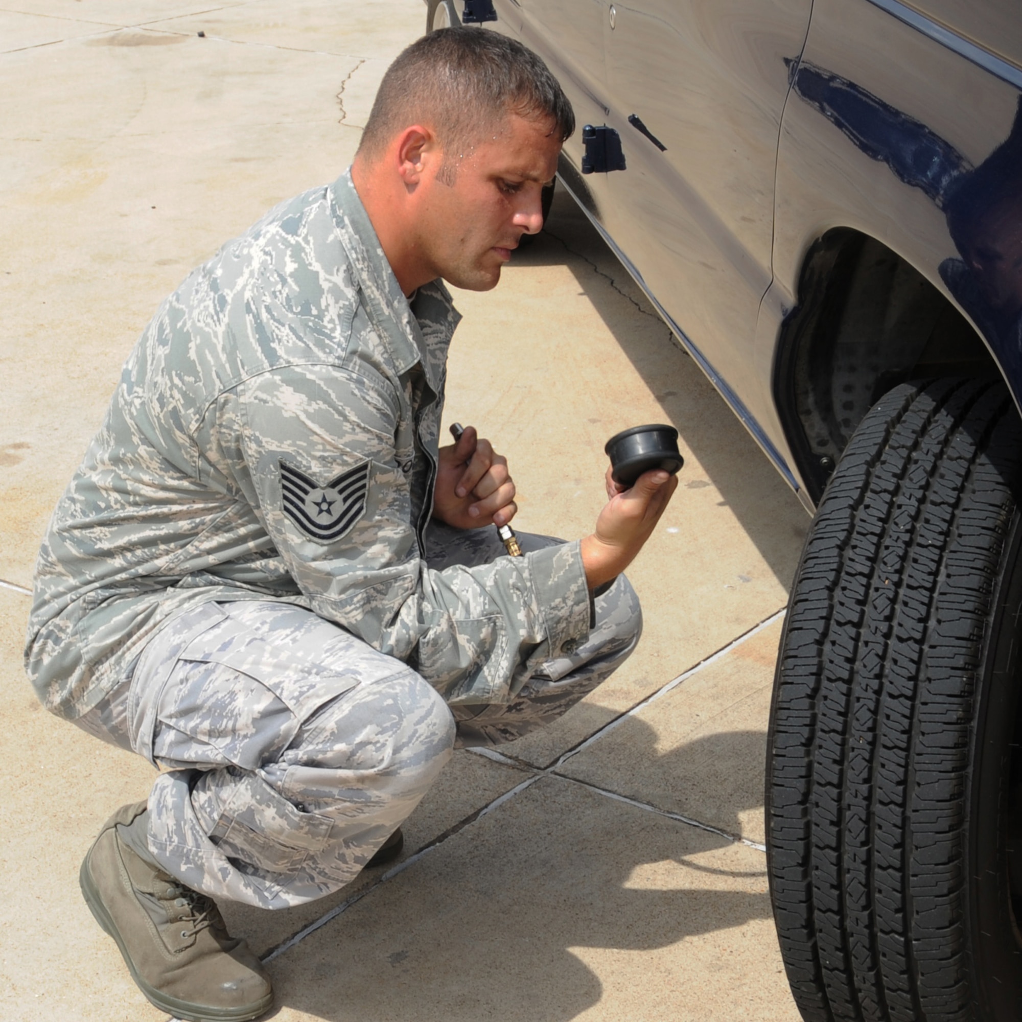 Tech. Sgt. Don Downey, 2nd Logistics Readiness Squadron equipment support NCO in charge, checks the tire pressure on a government operated vehicle on Barksdale Air Force Base, La., Sept. 13. Vehicle Operations is in charge of maintaining and inspecting all GOV?s on the base. (U.S. Air Force photo/Senior Airman Sean Martin) (RELEASED)
