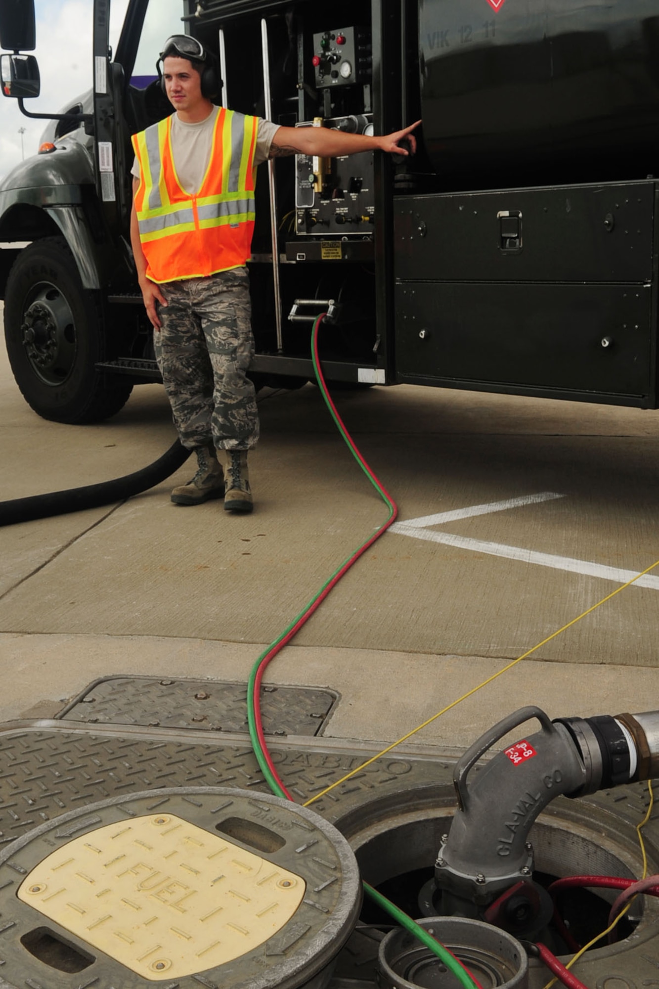 U.S. Air Force Airman 1st Class Jeremiah Garfoyle, 633rd Logistic Readiness Squadon refueling operator, prepares to attach a hose to an F-22 Raptor during a Hydrant Mobile Refueler procedure at Langley Air Force Base, Va., Sept. 13, 2012. With the HYMORE system, a hose is attached to an aircraft and allows fuel to be pumped directly from an underground hydrant system. (U.S. Air Force photo by Staff Sgt. Ashley Hawkins/Released)