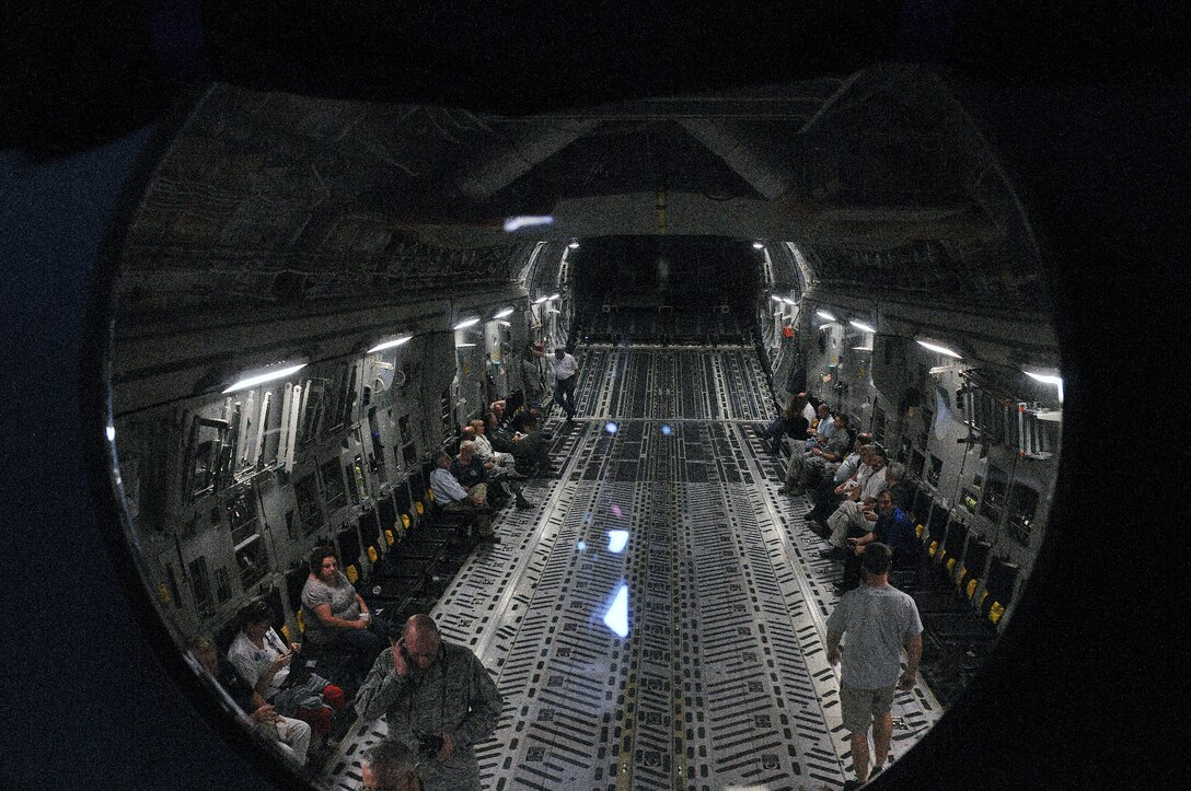 Reservists and their civilian employers mingle in the cargo area of a C-17 Globemaster III Sept. 8, 2012, during a a flight as part of the 512th Airlift Wing's annual Employer Appreciation Day at Dover Air Force Base, Del. The photo was taken through a window at the rear of the flight deck that allows crew members to view rear interior space of the airplane without having to go all of the way down to it. More than 30 people participated in the employer event, which also included a visit to a C-5 isochronal inspection hangar and a military working dog demonstration by the 436th Security Forces Squadron. (U.S. Air Force photo by Senior Airman Erika C. Brooke)