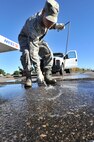 MINOT AIR FORCE BASE, N.D. -- Airman 1st Class Wilson Arocho and Senior Airman Sixto Trevino, 5th Civil Engineer Squadron water and fuel systems maintainers, pump water from a fuel tank here, Sept. 12. Keeping the water level down is a recurring maintenance job that keeps the fuel system running correctly. (U.S. Air Force photo/Senior Airman Brittany Y. Auld) 