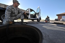 MINOT AIR FORCE BASE, N.D. -- Airman 1st Class Wilson Arocho and Senior Airman Sixto Trevino, 5th Civil Engineer Squadron water and fuel systems maintainers, pump water from a fuel tank here, Sept. 12. Keeping the water level down is a recurring maintenance job that keeps the fuel system running correctly. (U.S. Air Force photo/Senior Airman Brittany Y. Auld) 