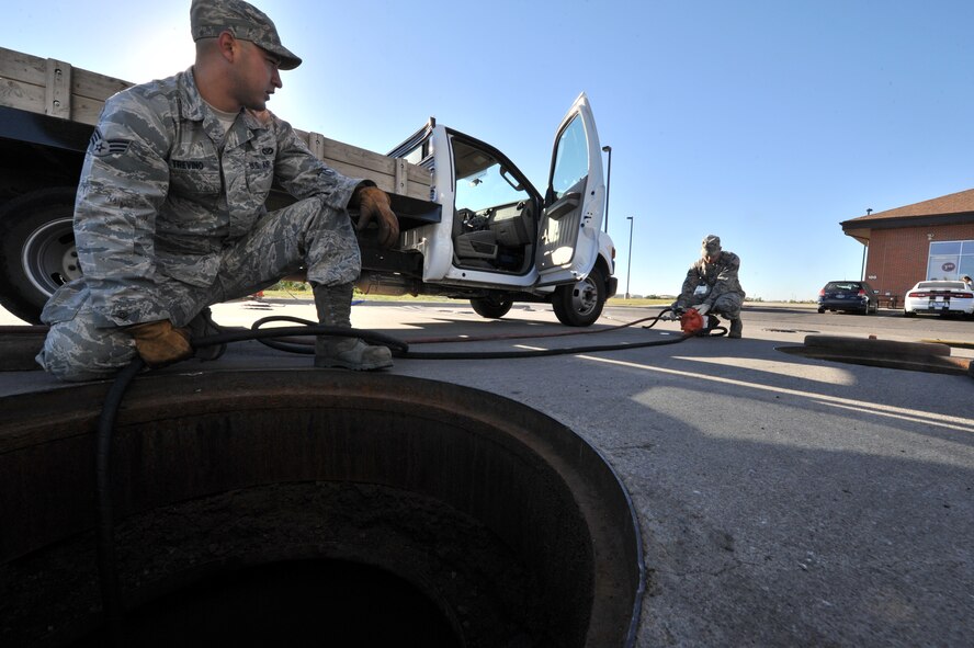 MINOT AIR FORCE BASE, N.D. -- Airman 1st Class Wilson Arocho and Senior Airman Sixto Trevino, 5th Civil Engineer Squadron water and fuel systems maintainers, pump water from a fuel tank here, Sept. 12. Keeping the water level down is a recurring maintenance job that keeps the fuel system running correctly. (U.S. Air Force photo/Senior Airman Brittany Y. Auld) 