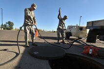 MINOT AIR FORCE BASE, N.D. -- Senior Airman Sixto Trevino and Airman 1st Class Wilson Arocho, 5th Civil Engineer Squadron water and fuel systems maintainers, prepare their equipment to perform maintenance on a fuel tank here, Sept. 12. Keeping the water level down is a recurring maintenance job that keeps the fuel system running correctly. (U.S. Air Force photo/Senior Airman Brittany Y. Auld)