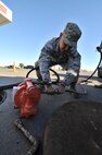 MINOT AIR FORCE BASE, N.D. -- Senior Airman Sixto Trevino, 5th Civil Engineer Squadron water and fuel systems maintainer, prepares his equipment to perform work on a fuel tank here, Sept. 12. Keeping the water level down is a recurring maintenance job that keeps the fuel system running correctly. (U.S. Air Force photo/Senior Airman Brittany Y. Auld)